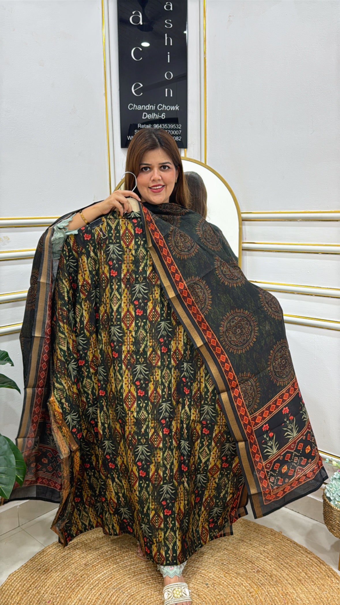 Model showcasing a Banglori raw silk unstitched suit with intricate floral patterns and a flowing design