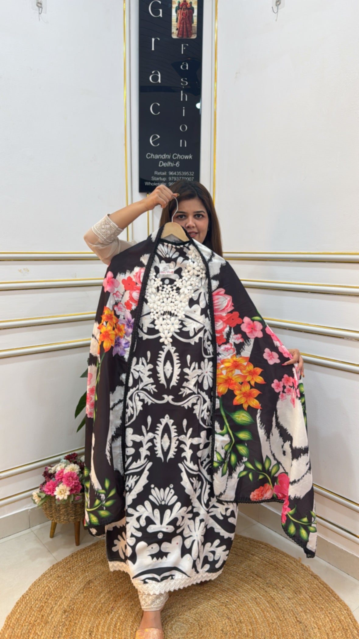 Woman wearing a beautiful digital printed muslin suit featuring floral designs and elegant patterns