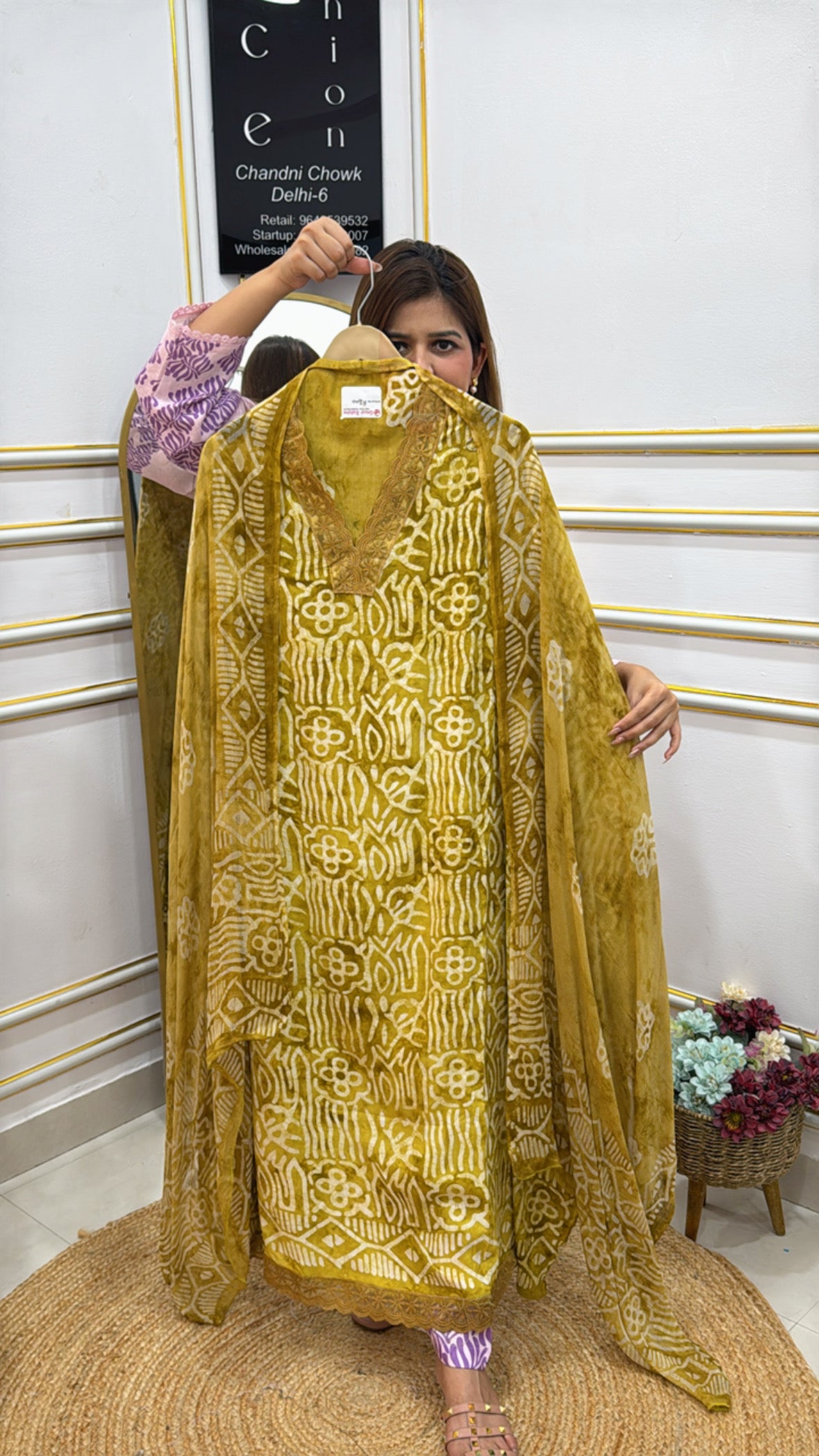 Stylish model showcasing Cotton Maheshwari batik fabric in vibrant yellow with intricate designs