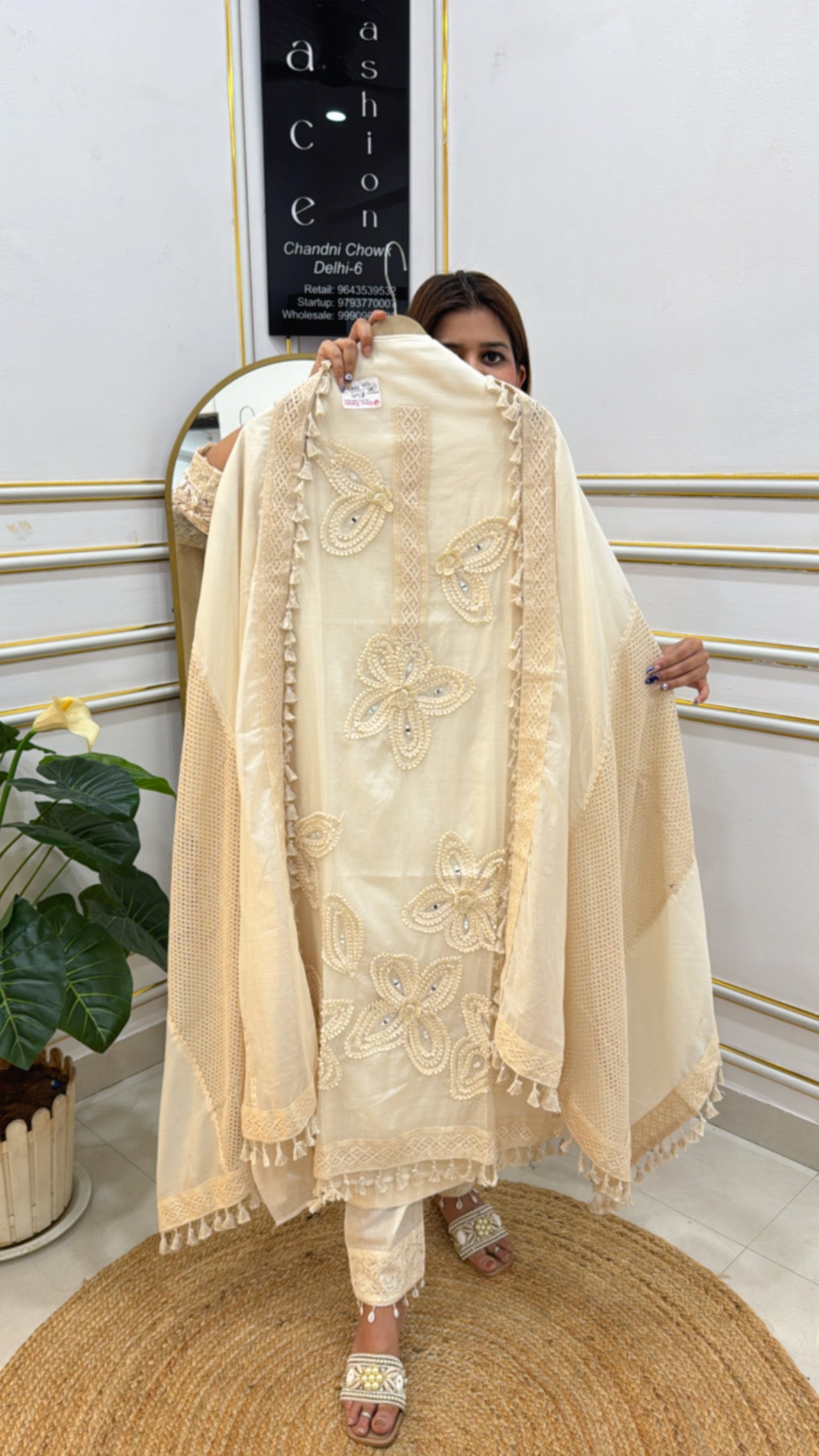 Elegant cotton suit set in cream color with intricate embroidery and tassel detailing, perfect for festive occasions