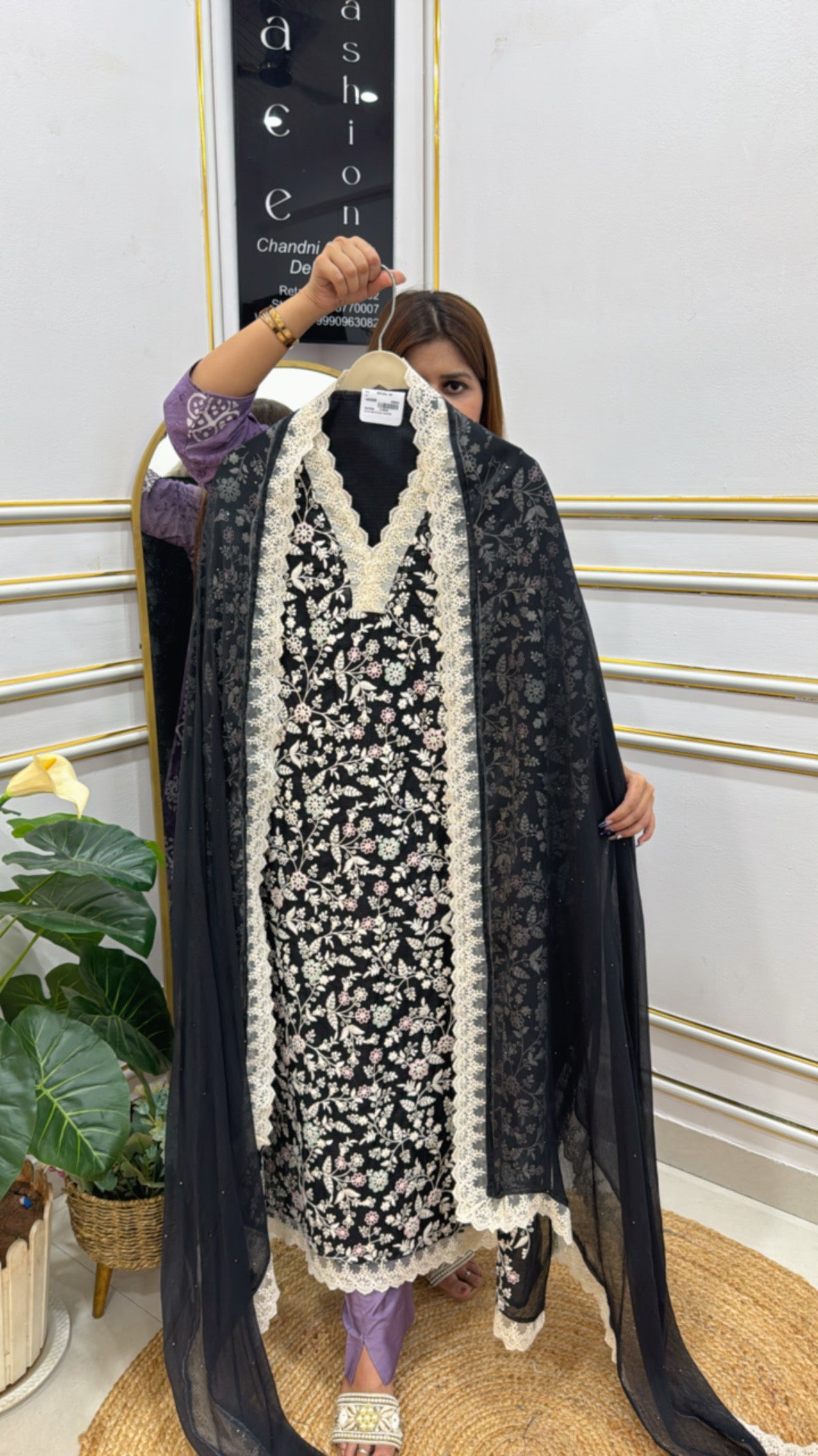 Kota Doria unstitched suit in black with intricate floral embroidery, draped on a model