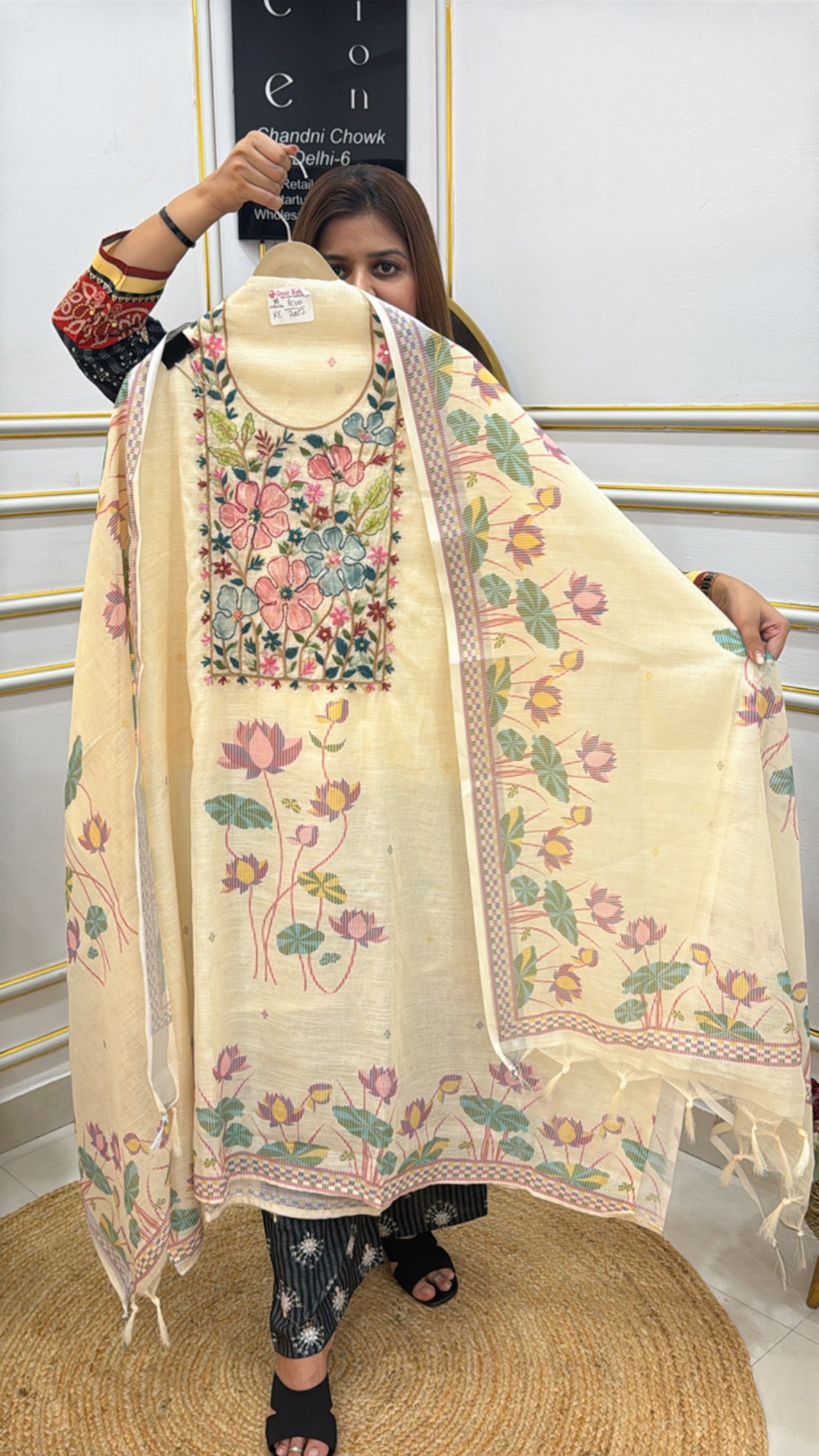 Elegant linen Jamdhani suit with floral embroidery and intricate design held by a model