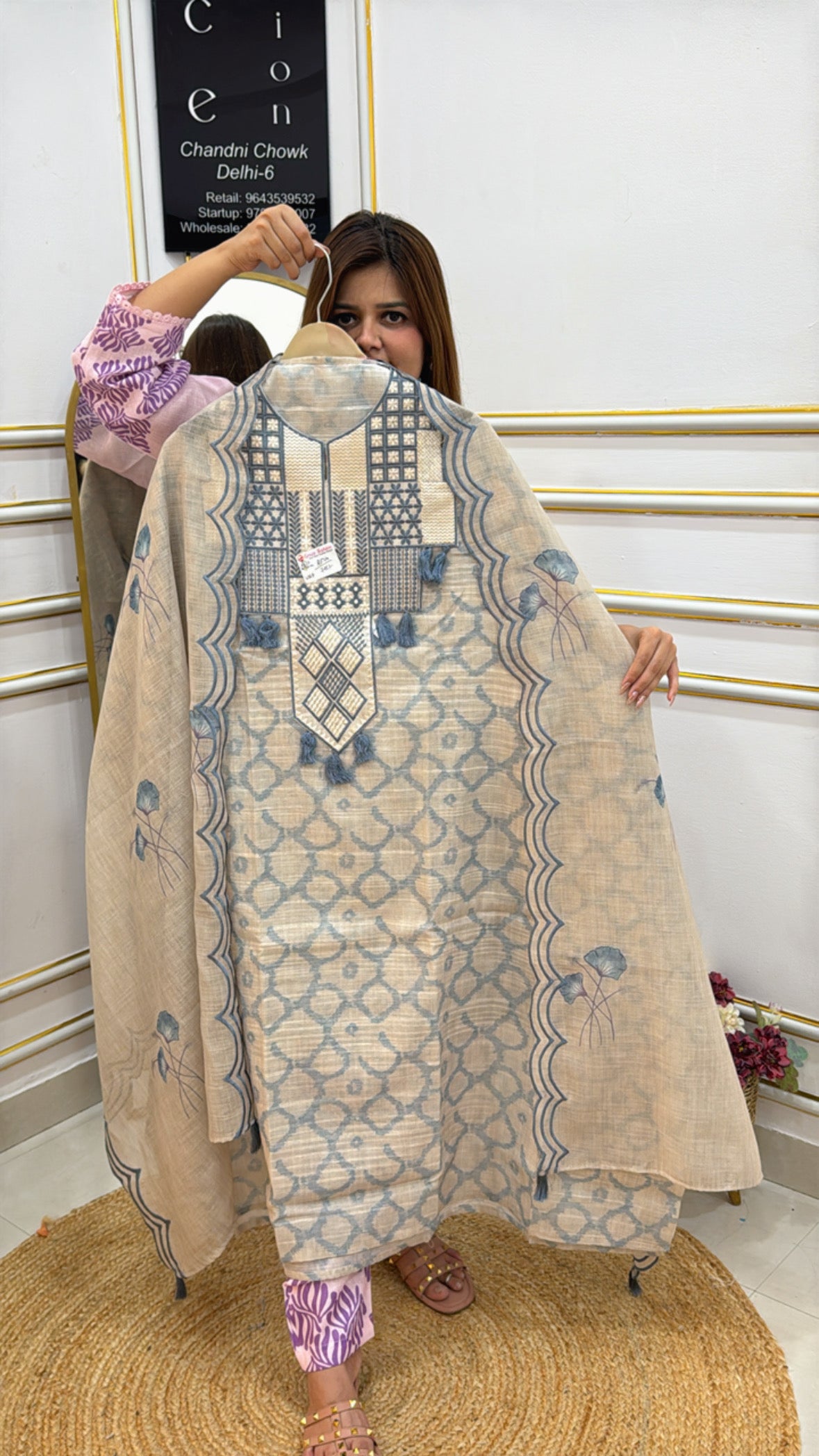 Woman showcasing a beautiful linen Jamdhani unstitched suit with intricate patterns and designs