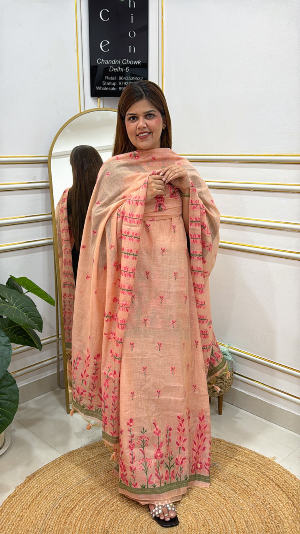 Woman wearing a beautiful linen jamdhani unstitched suit with floral embroidery in soft peach color