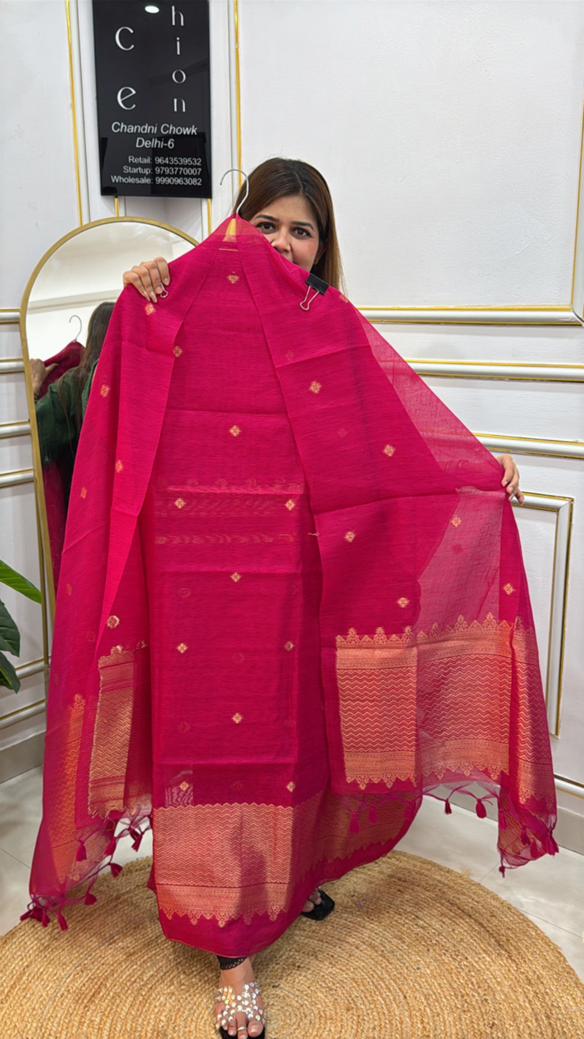 Woman showcasing a vibrant Linen Jamdhani unstitched suit with intricate patterns and elegant drapes