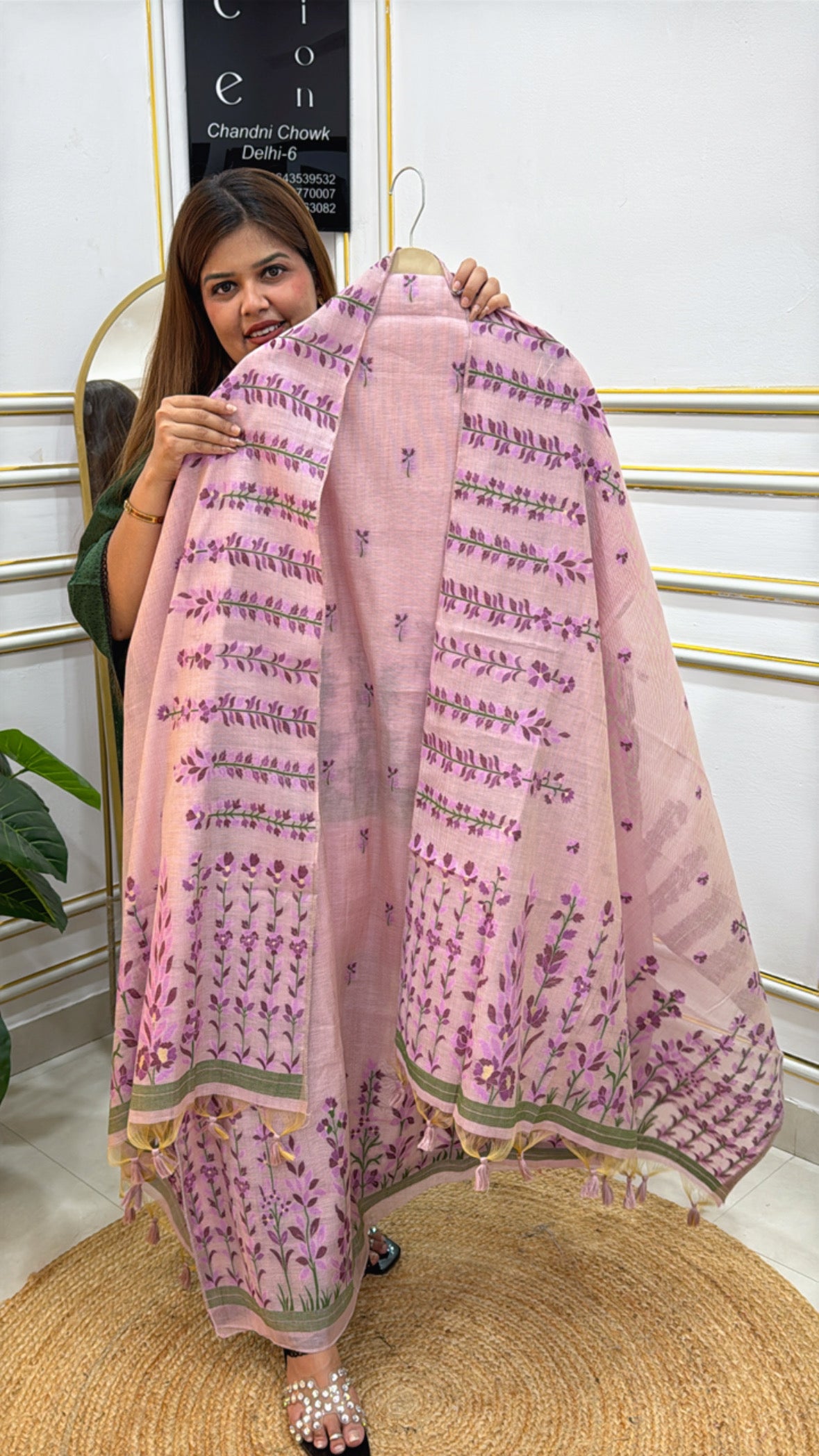 Woman showcasing a pink linen jamdhani unstitched suit with floral embroidery and decorative borders