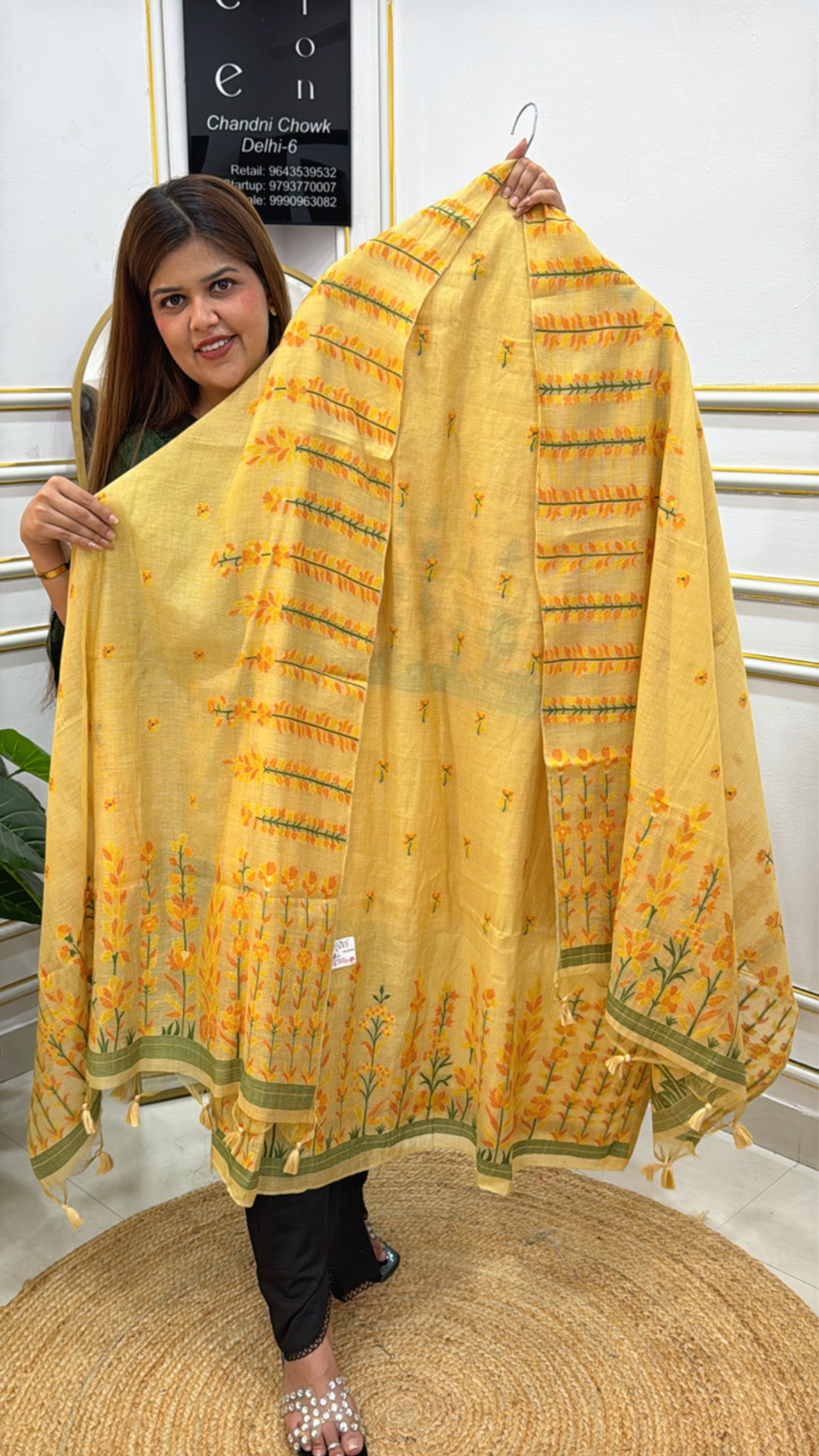 Beautiful yellow linen jamdhani unstitched suit with intricate floral embroidery displayed by a model
