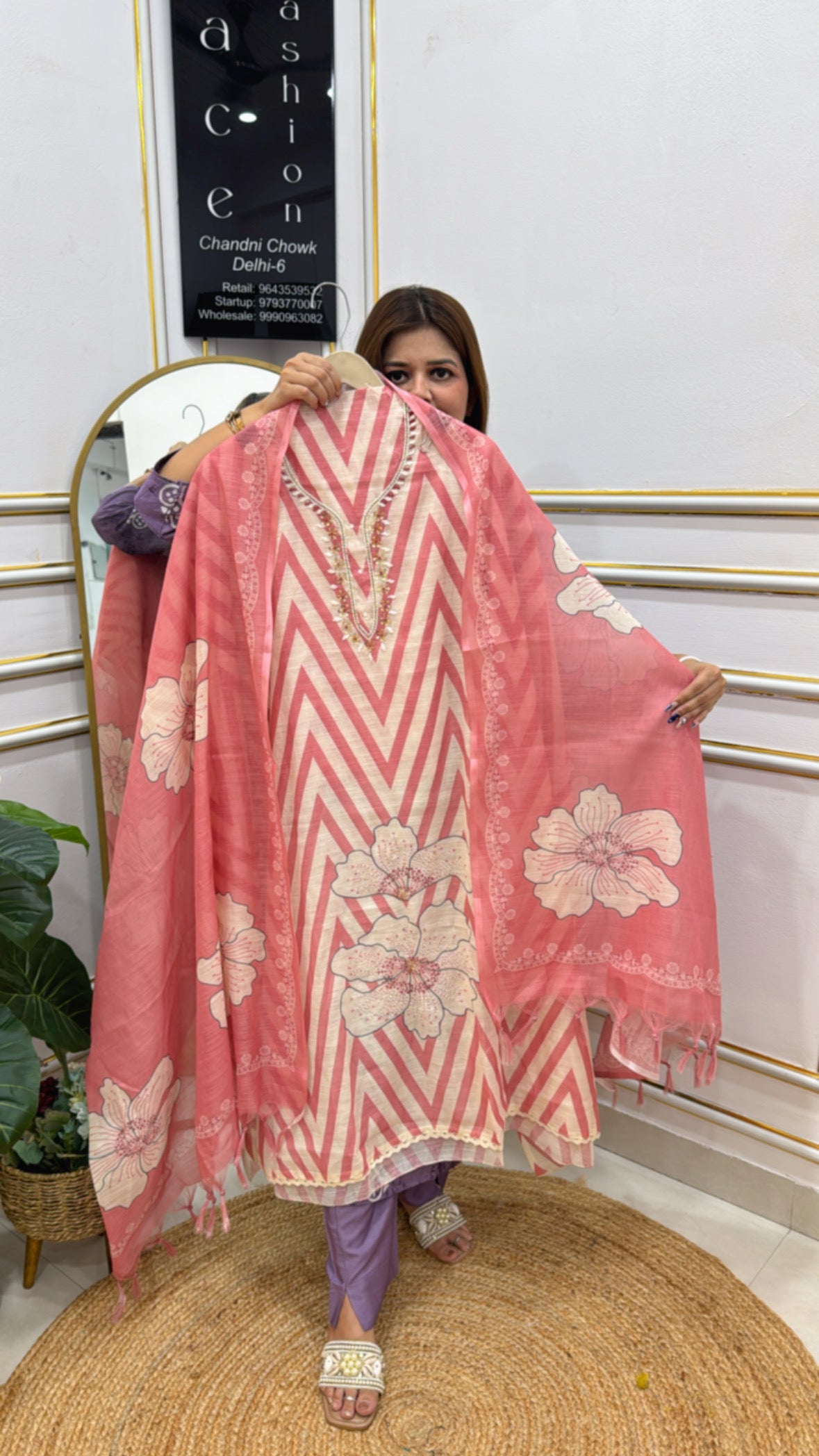 Model displaying a pink linen shirt fabric unstitched with floral patterns and zigzag design