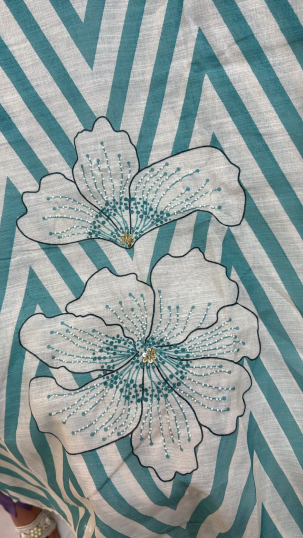 Floral patterned linen shirt fabric unstitched with turquoise chevron stripes and detailed flower embroidery