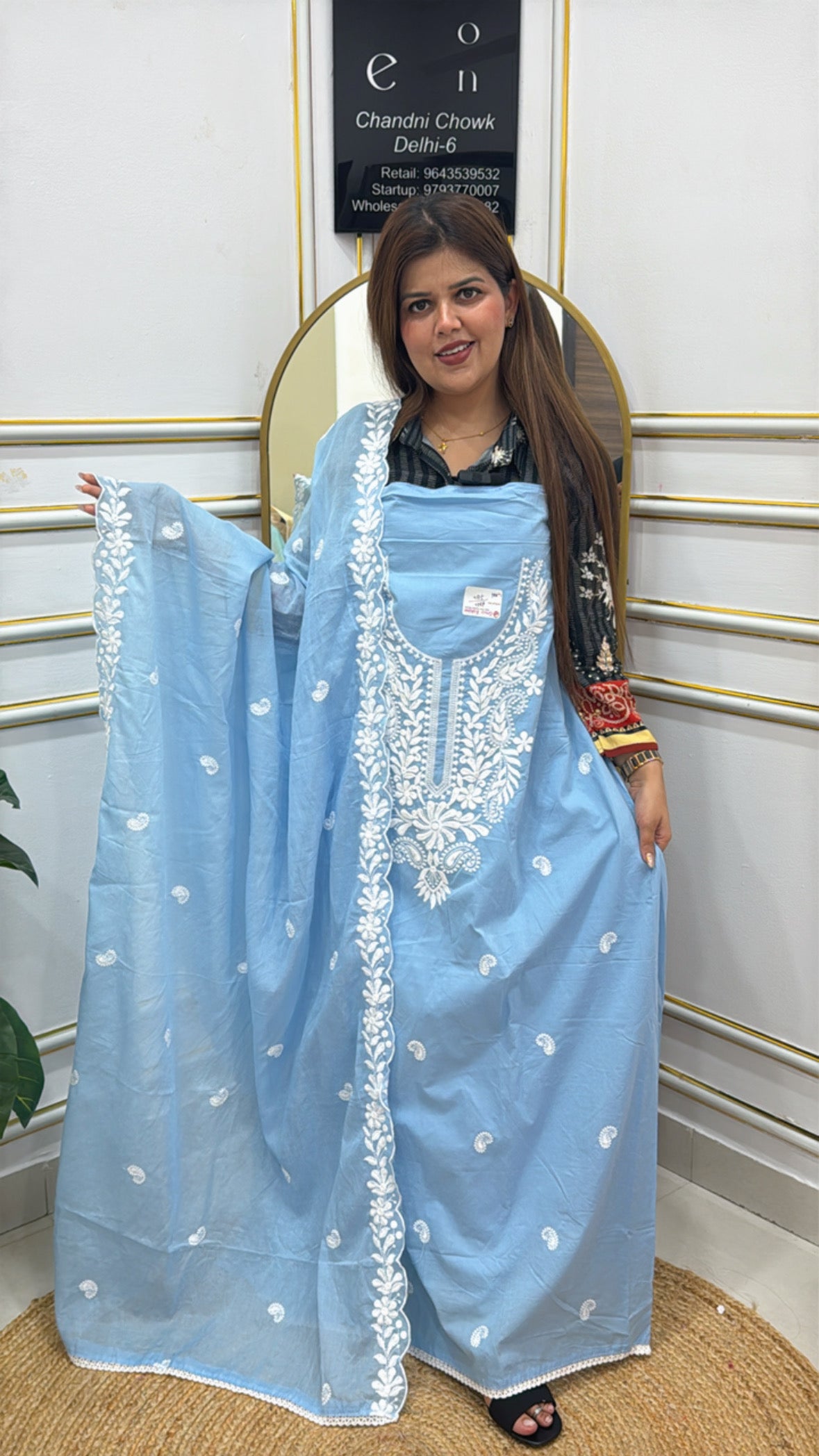 Light blue Lucknowi cotton suit material with intricate white embroidery, displayed by a model