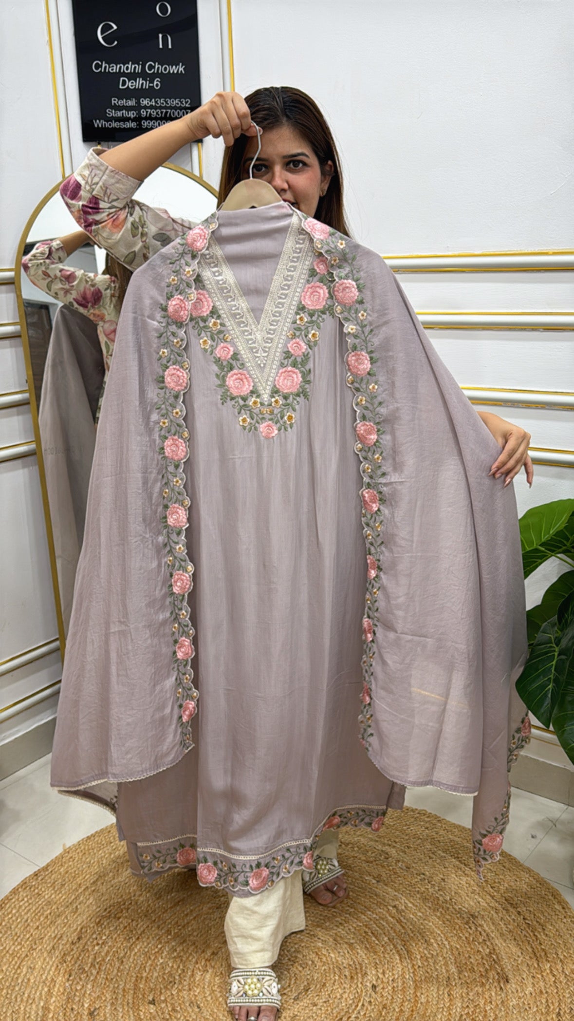 Model wearing a stylish modal cotton designer suit with floral embroidery and elegant detailing