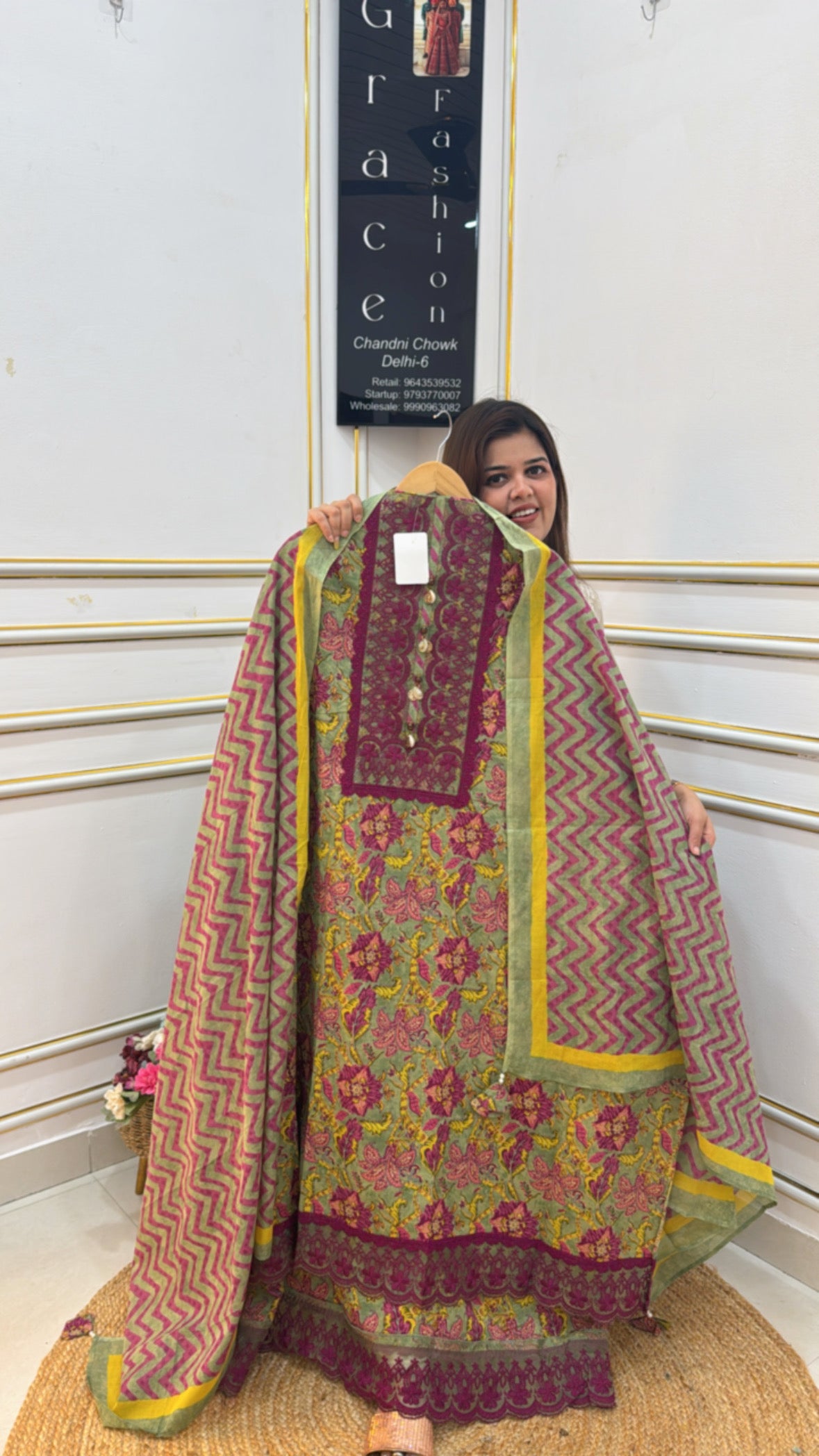 Woman showcasing a vibrant premium cotton shirt with floral and zigzag patterns in a stylish display