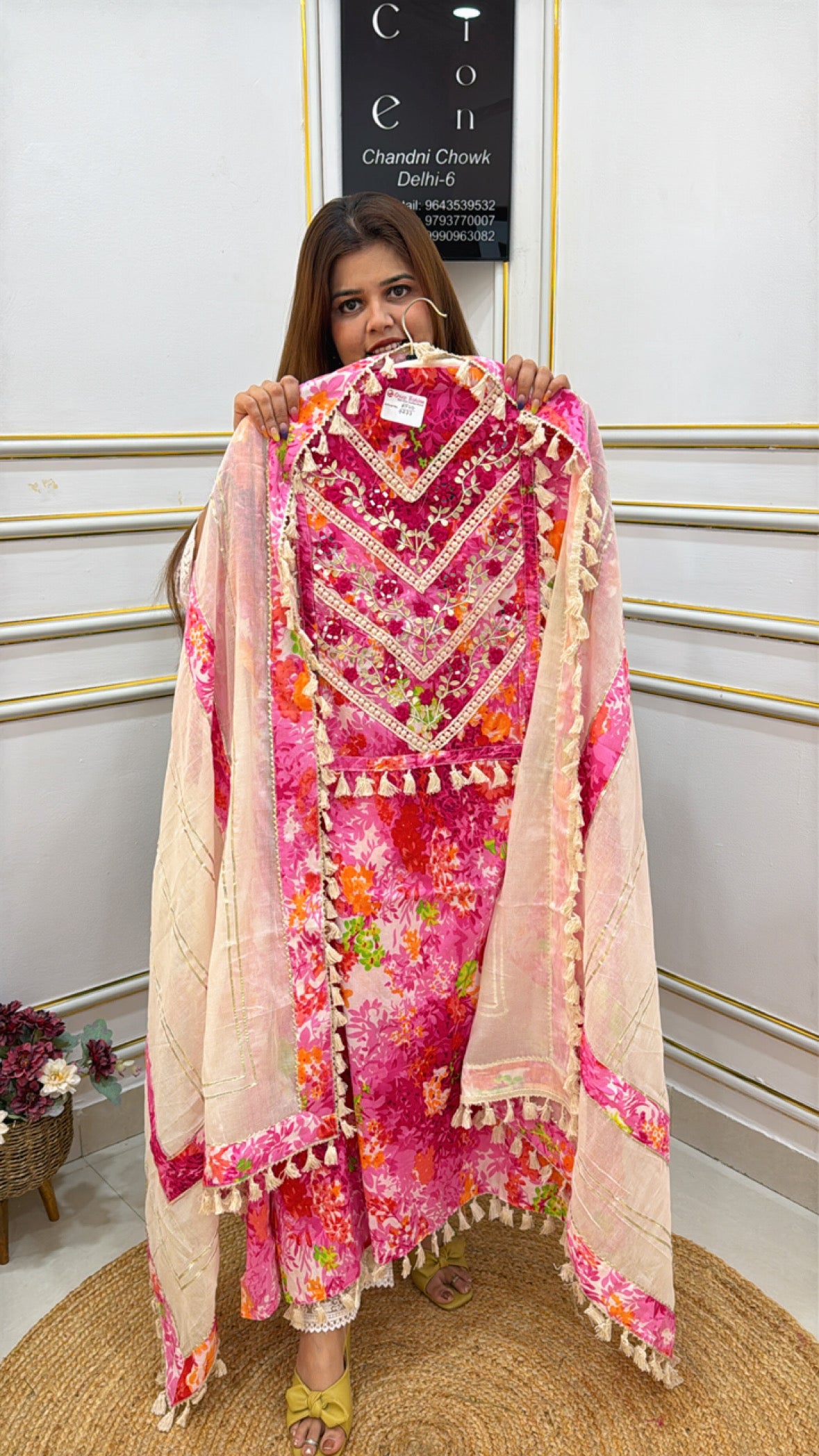 Model showcasing a premium cotton shirt with lace in vibrant floral patterns and pom-pom detailing