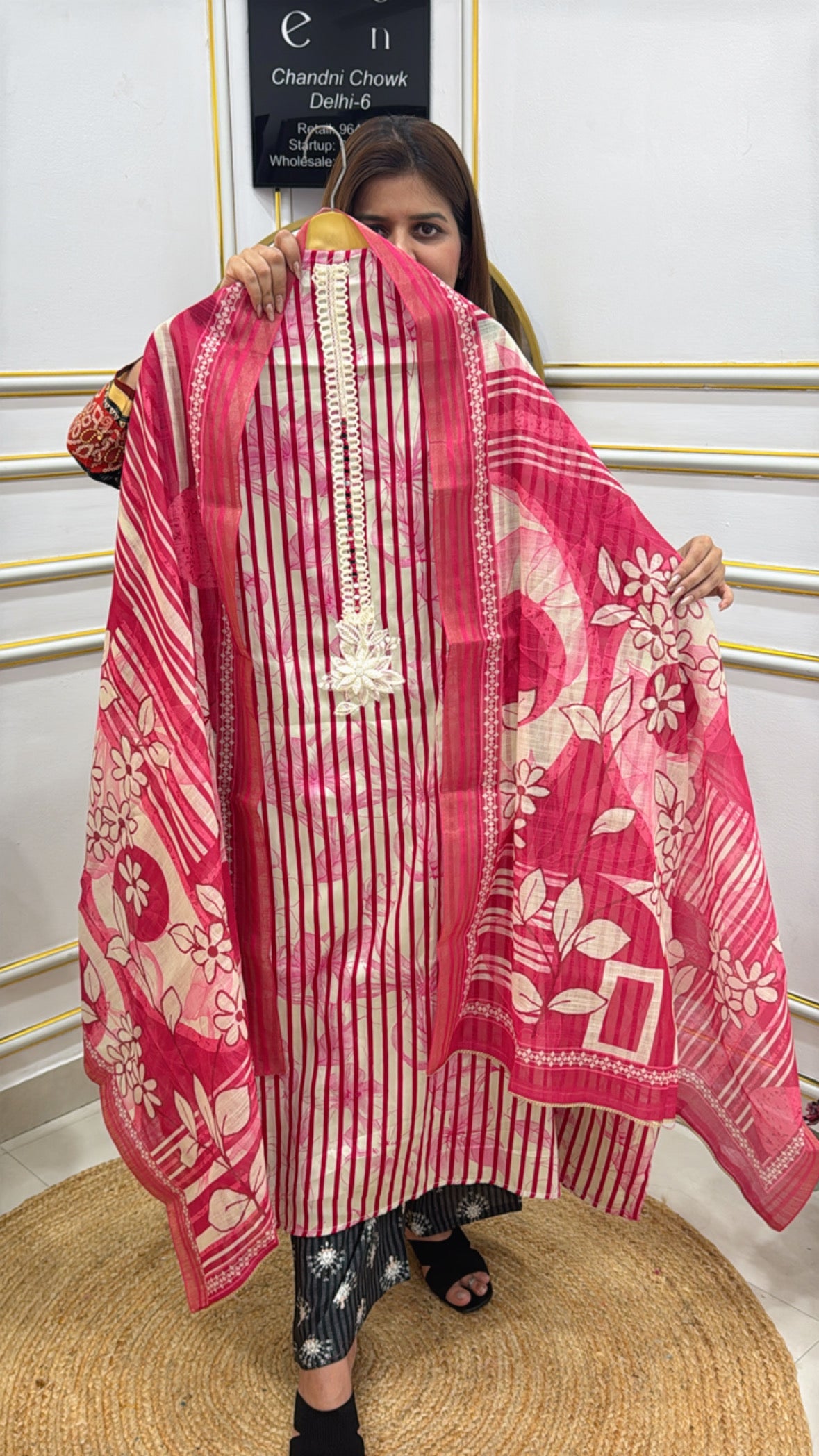 Model showcasing a premium cotton shirt with pearl details in vibrant pink and floral patterns