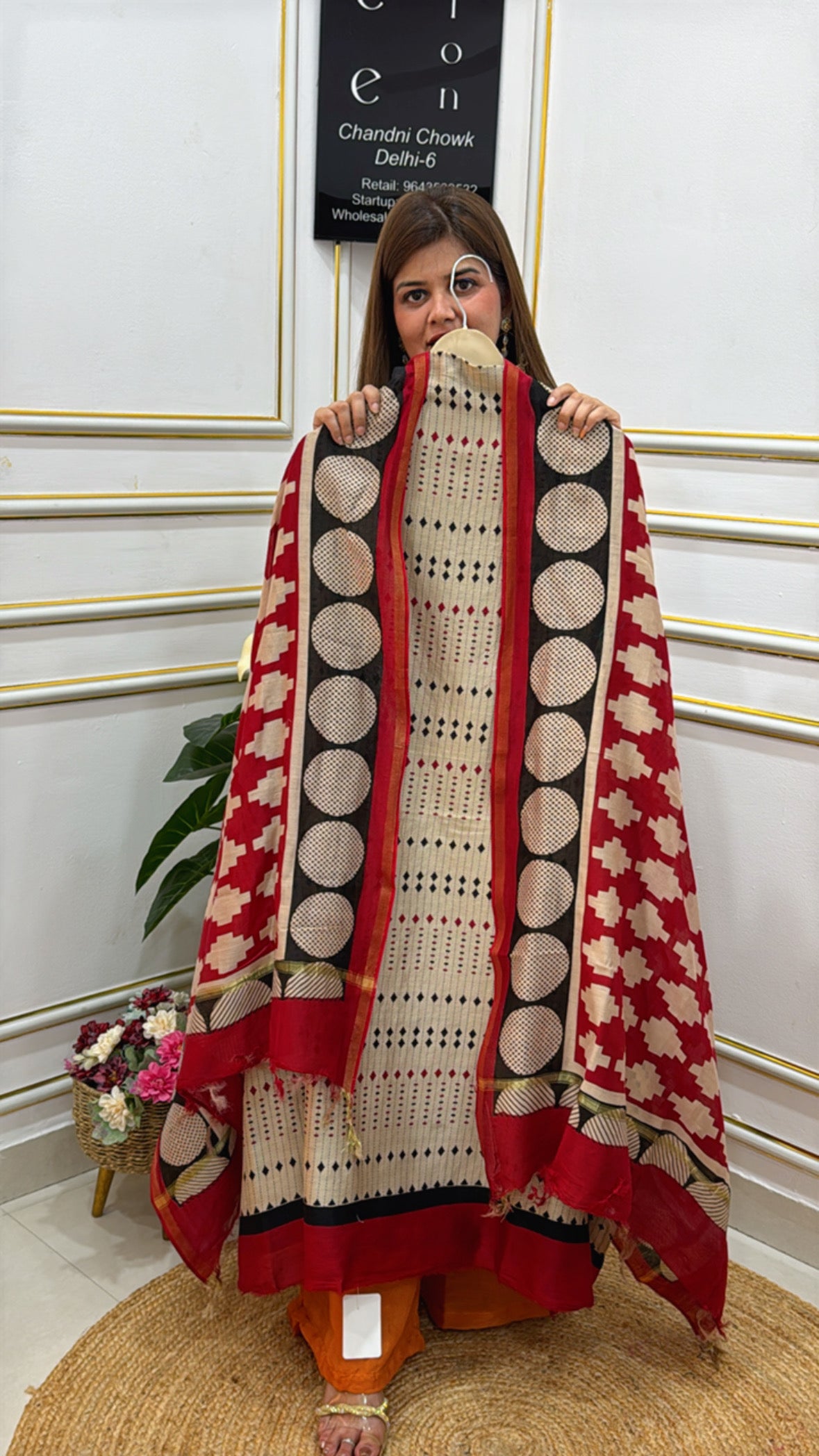 Elegant woman wearing premium cotton silk suits with intricate patterns and vibrant red accents