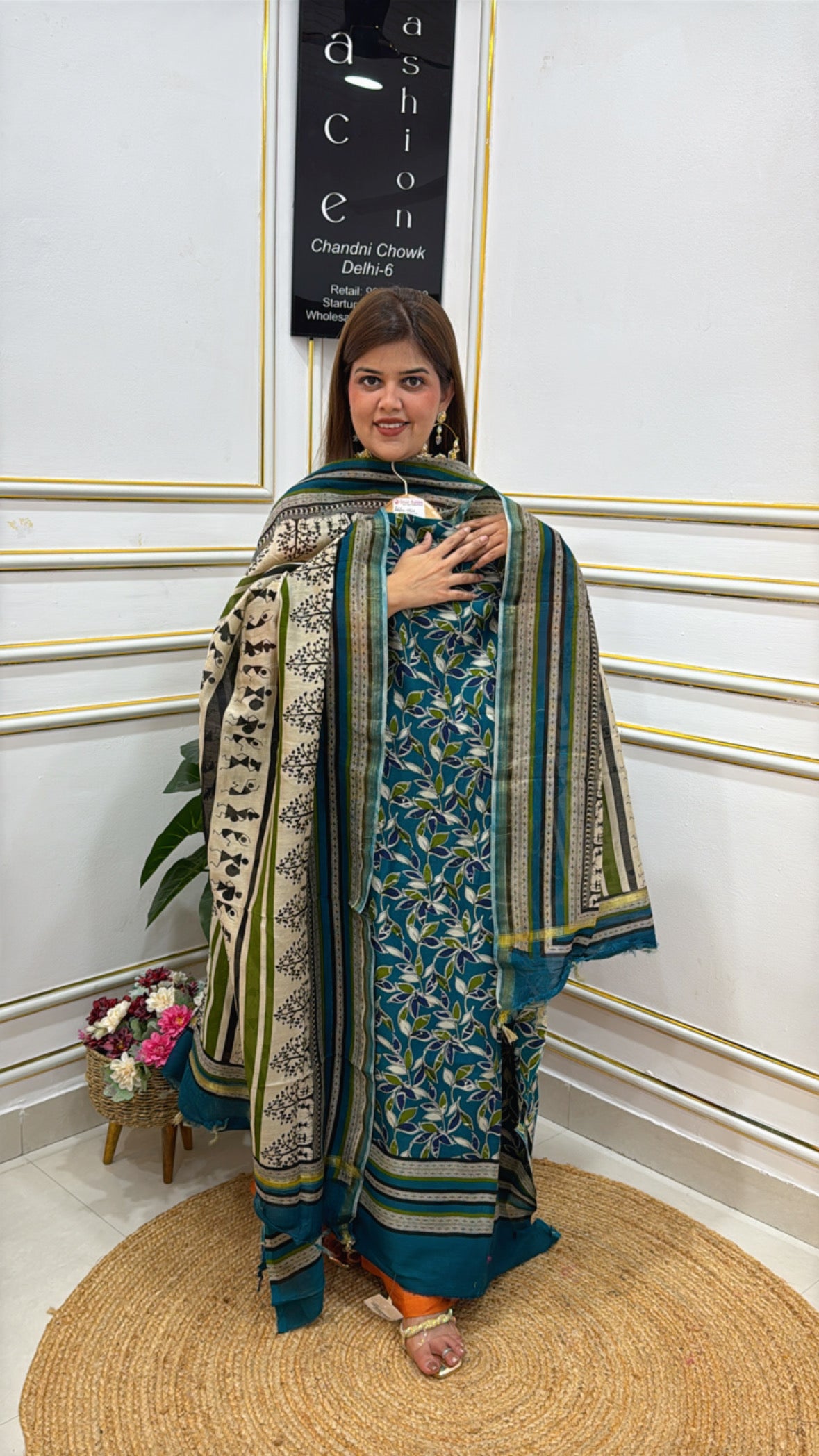 Elegant model showcasing a vibrant premium cotton silk suit with intricate patterns and rich colors