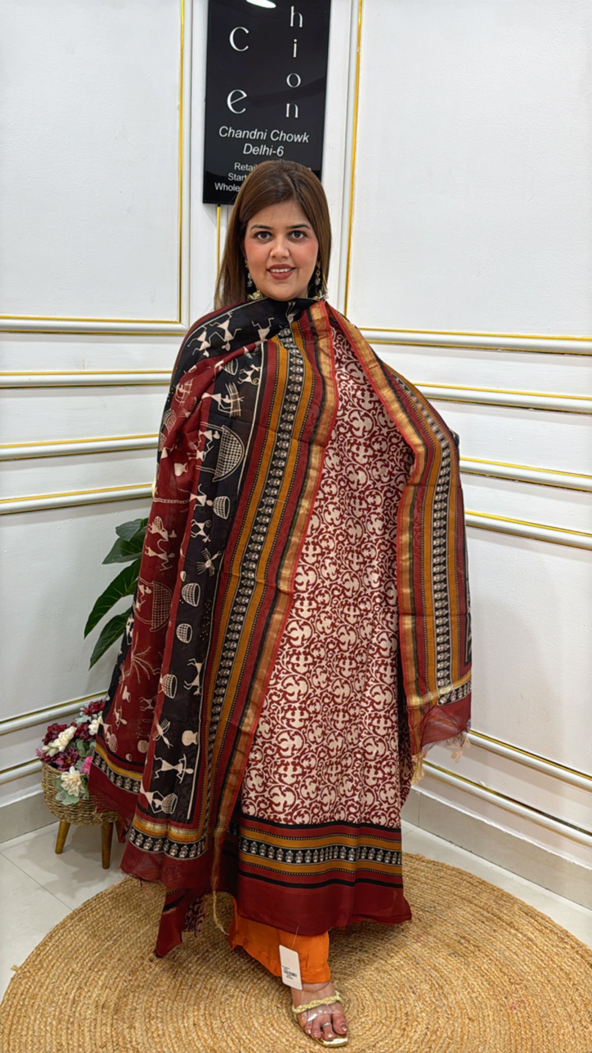 Elegant model showcasing premium cotton silk suits with intricate patterns and vibrant colors