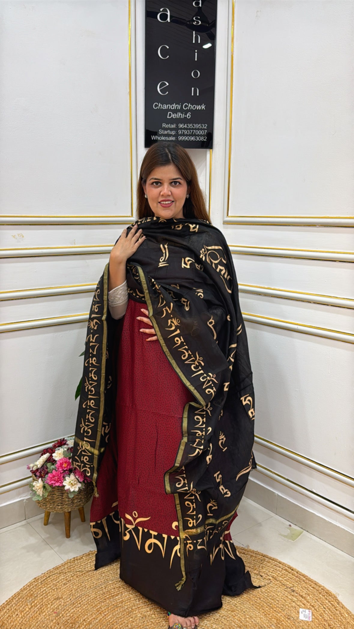 Elegant woman wearing a premium cotton silk suit with intricate gold detailing and a matching dupatta