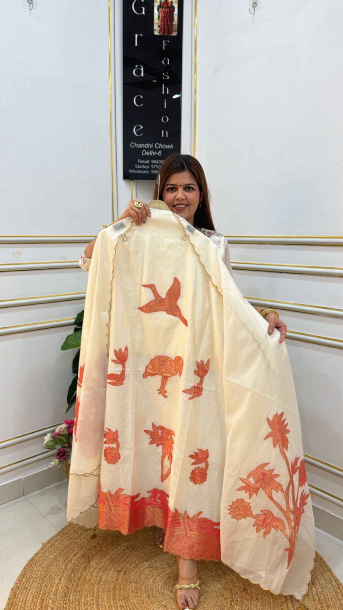 Beautiful model showcasing a Premium cotton silk unstitched suit with intricate bird and flower prints