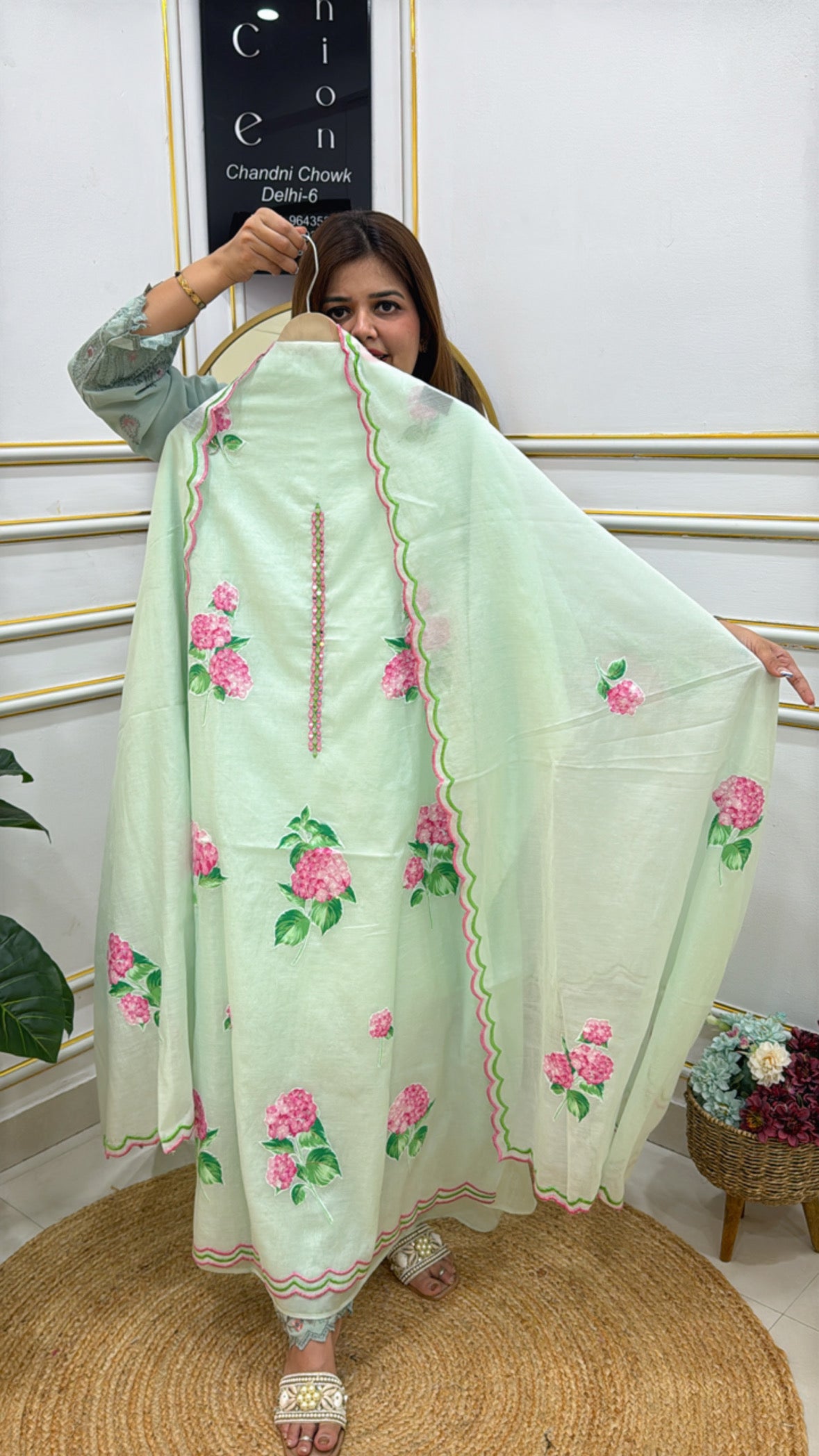 Model showcasing a Premium cotton silk unstitched suit with floral design in soft green