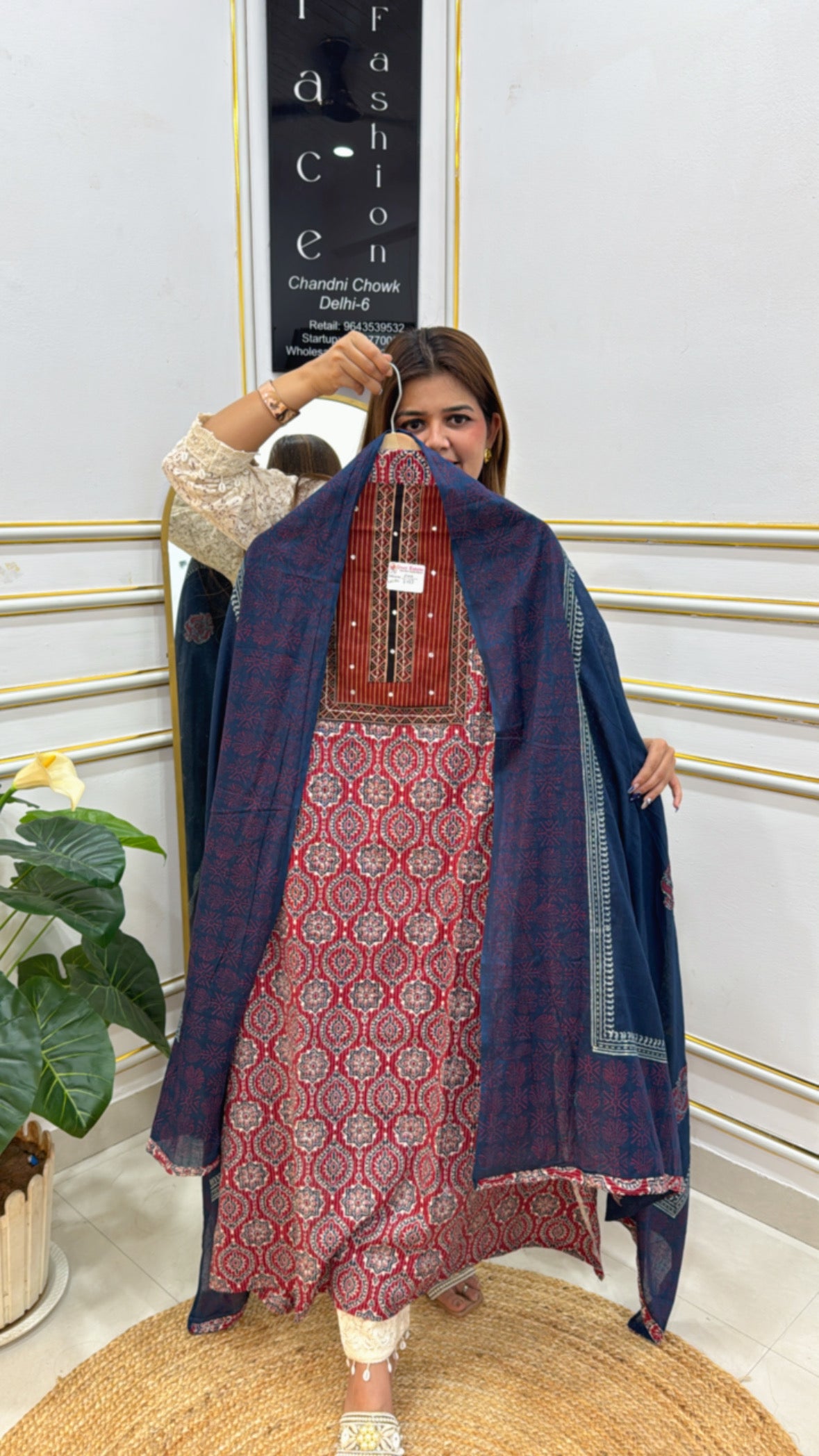 Woman holding a premium cotton unstitched suit with vibrant patterns and contrasting dupatta for stylish outfits