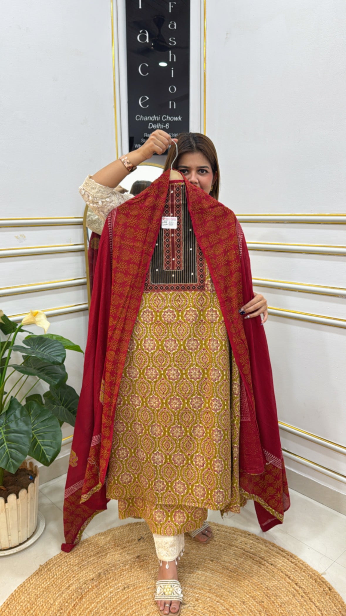 Elegant model showcasing premium cotton unstitched suit with intricate patterns and vibrant colors