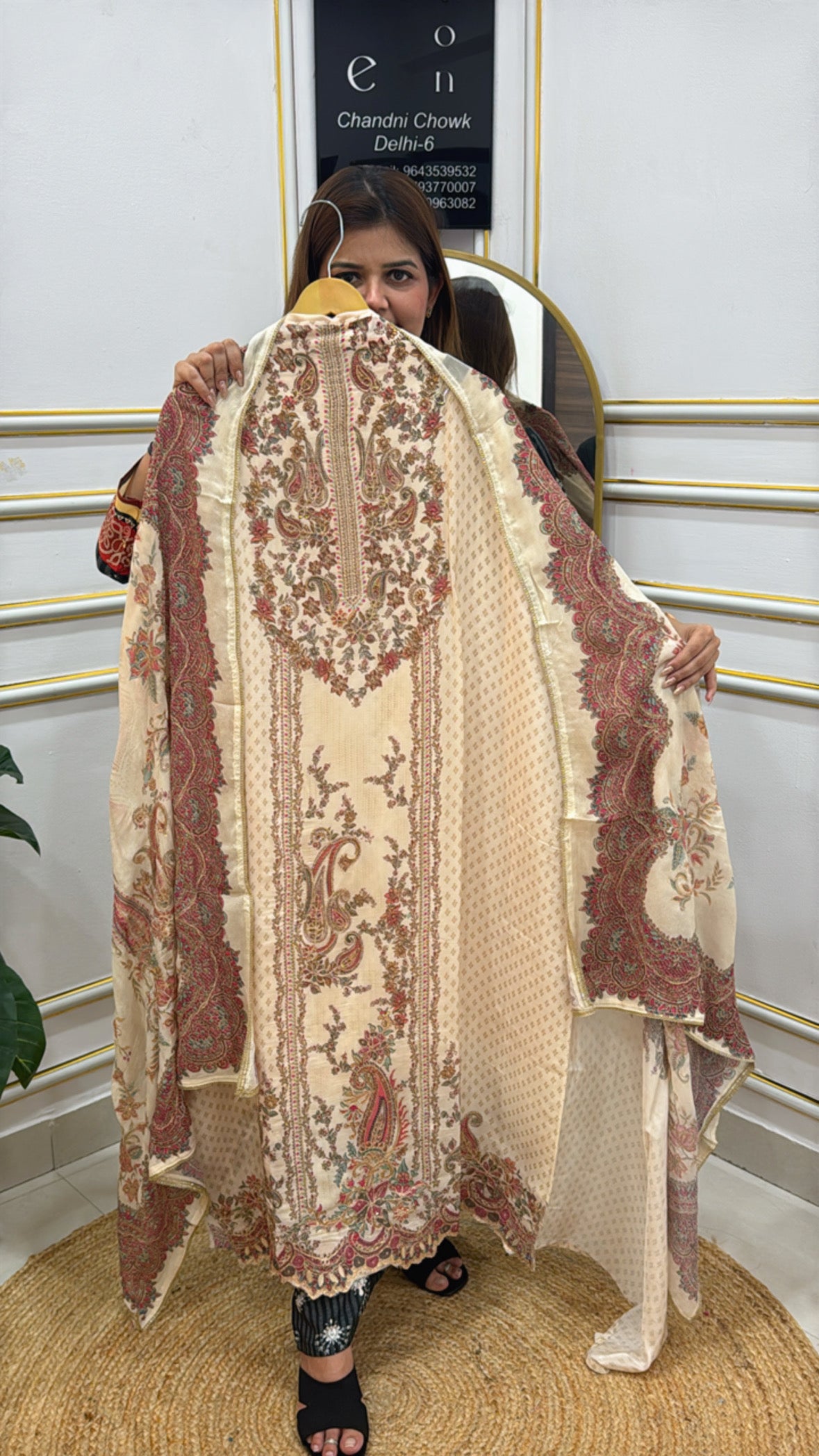 Woman showcasing a premium crape digital print suit with intricate patterns and elegant design