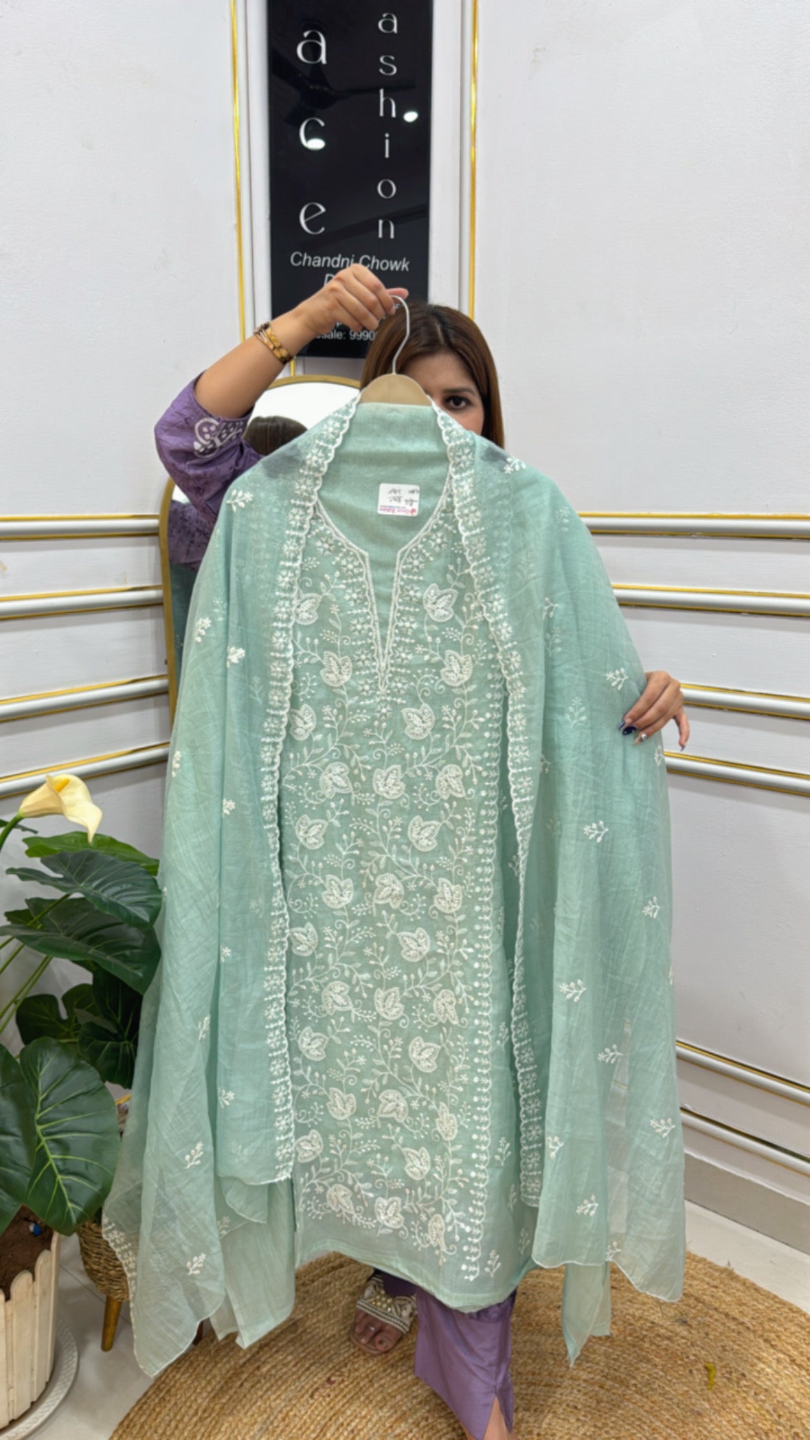 Premium embroidered cotton silk suit in pastel green with intricate floral patterns and a matching dupatta