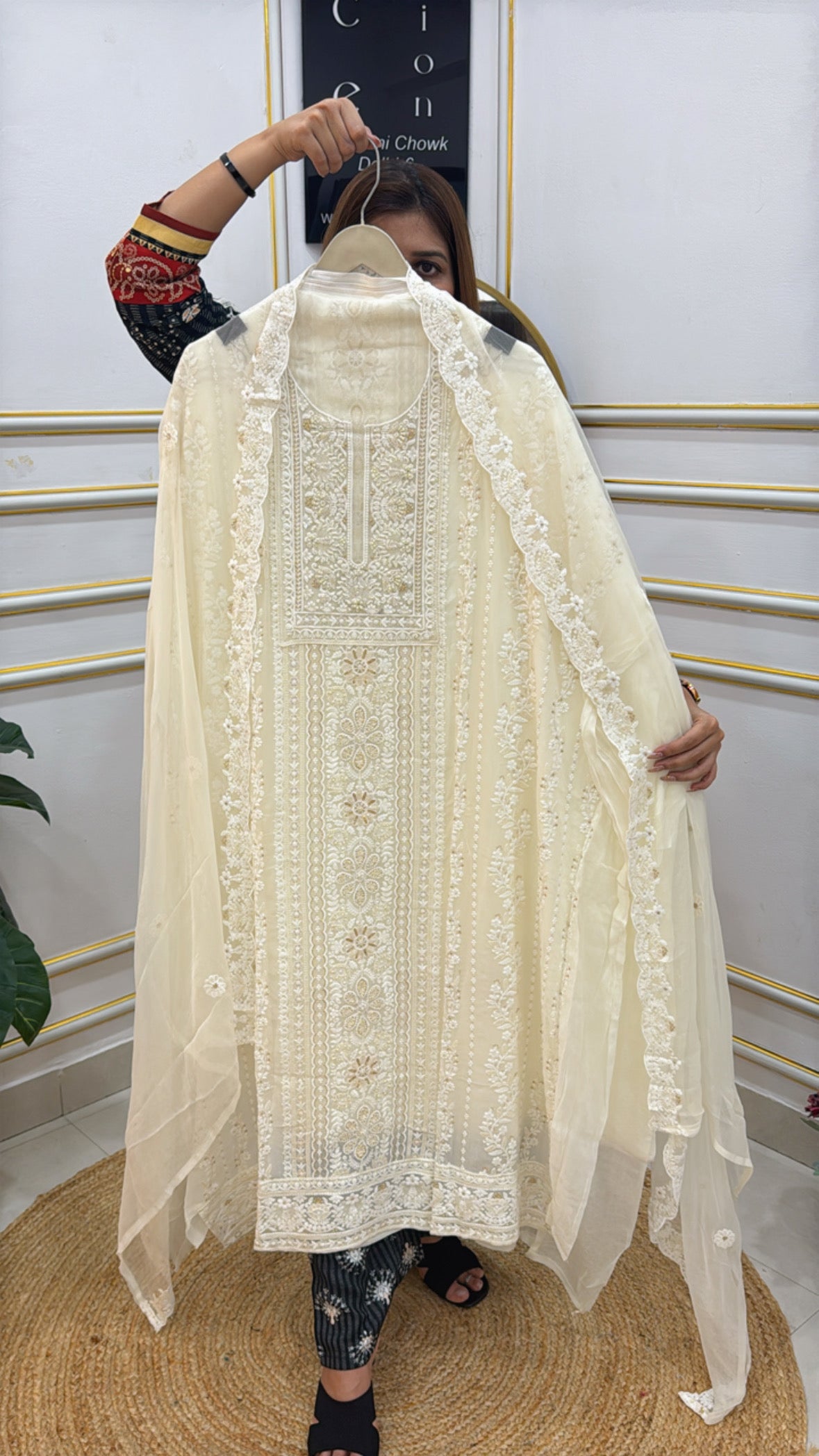 Elegant model showcasing a premium Lucknowi unstitched suit in cream with intricate embroidery