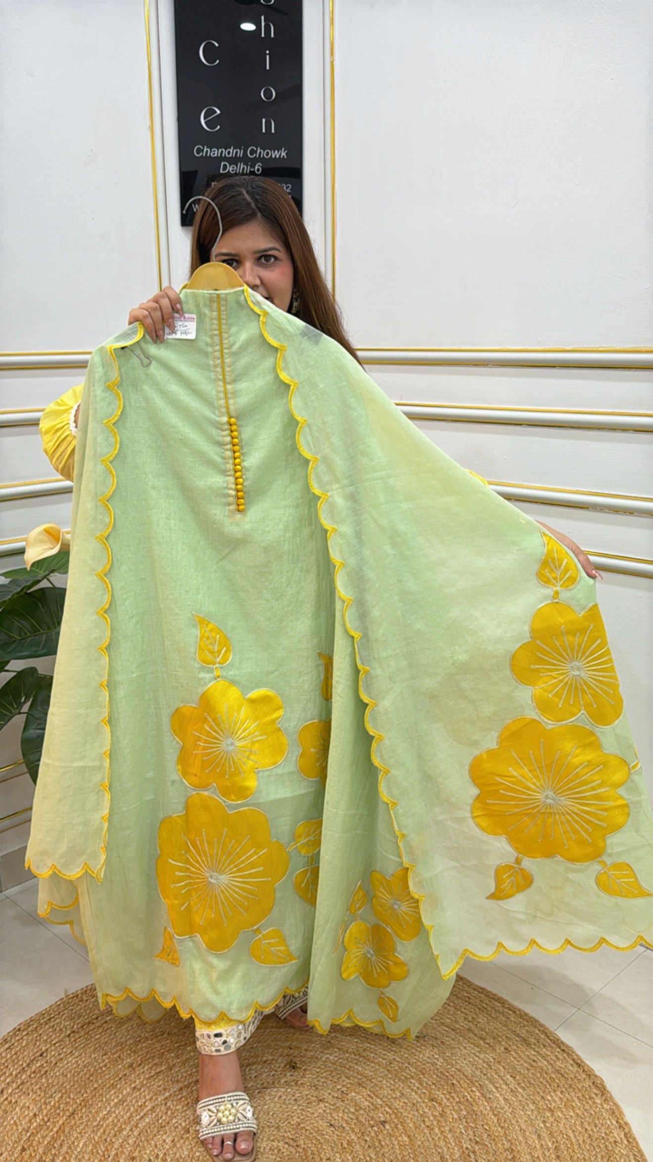 Elegant premium mal cotton silk suit in light green with vibrant yellow floral design and elegant stitching details
