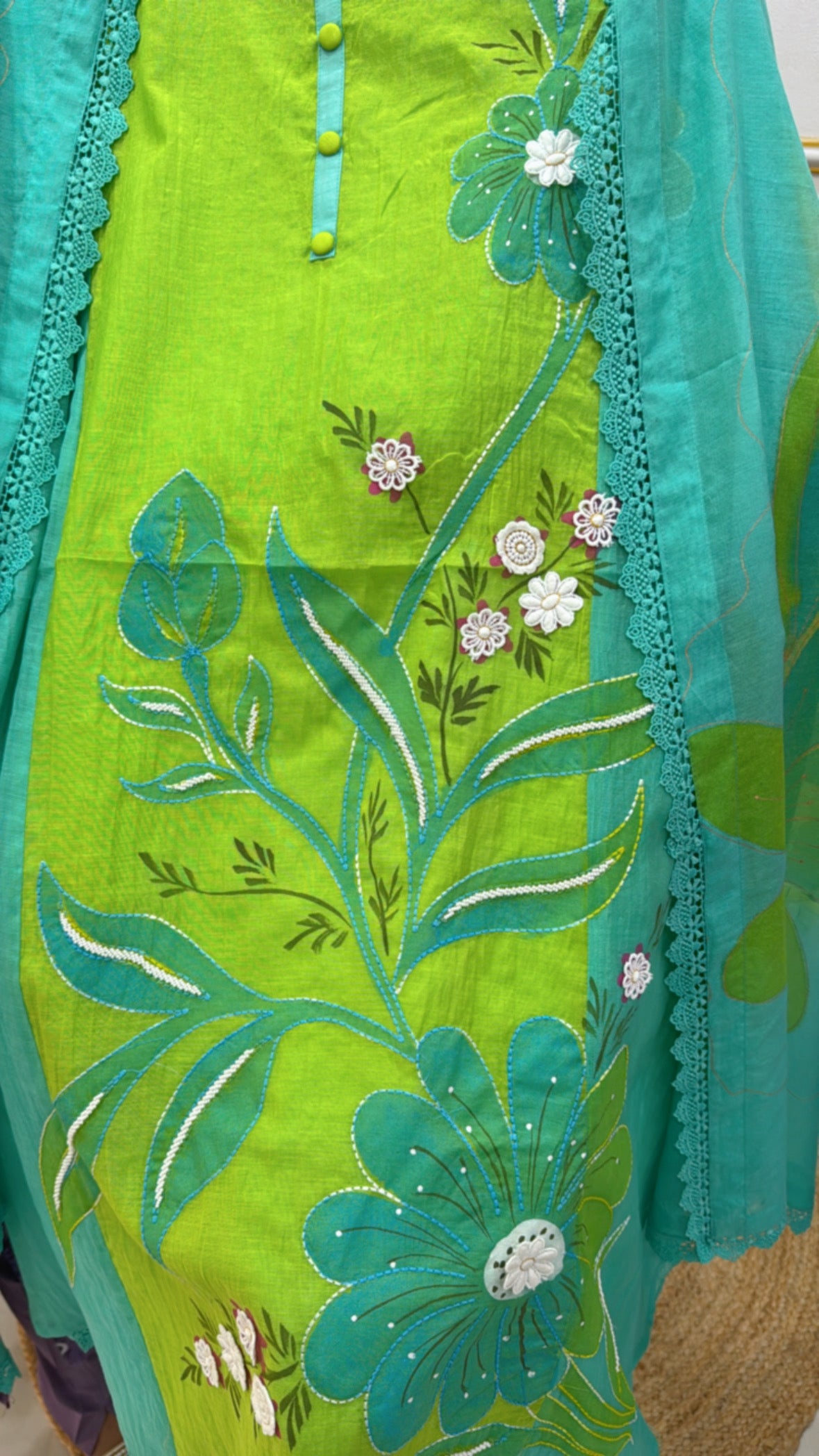 Premium neonish cotton suits featuring vibrant floral embroidery and detailed button accents