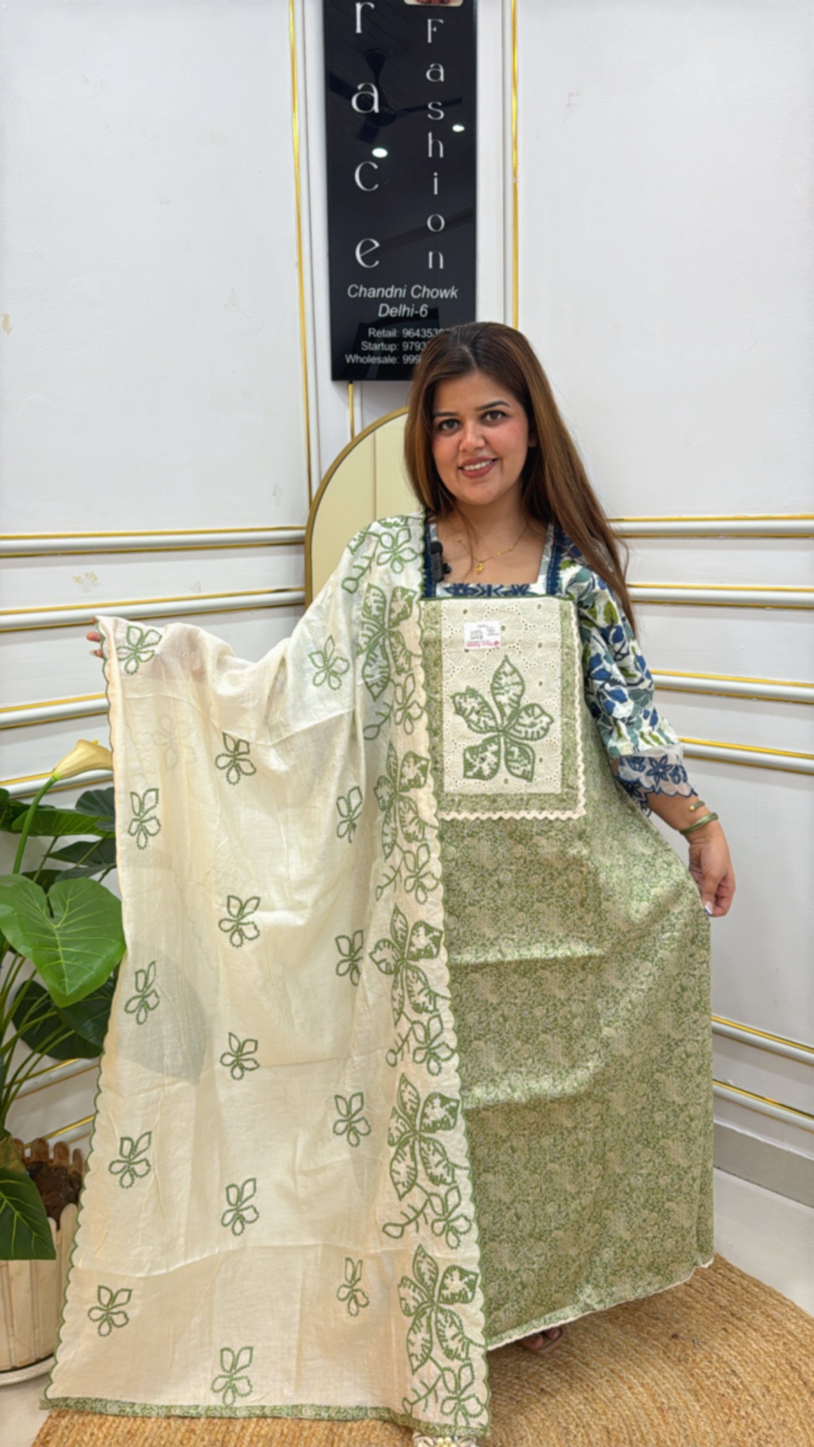 Model wearing a green and cream premium soft cotton suits with intricate floral embroidery