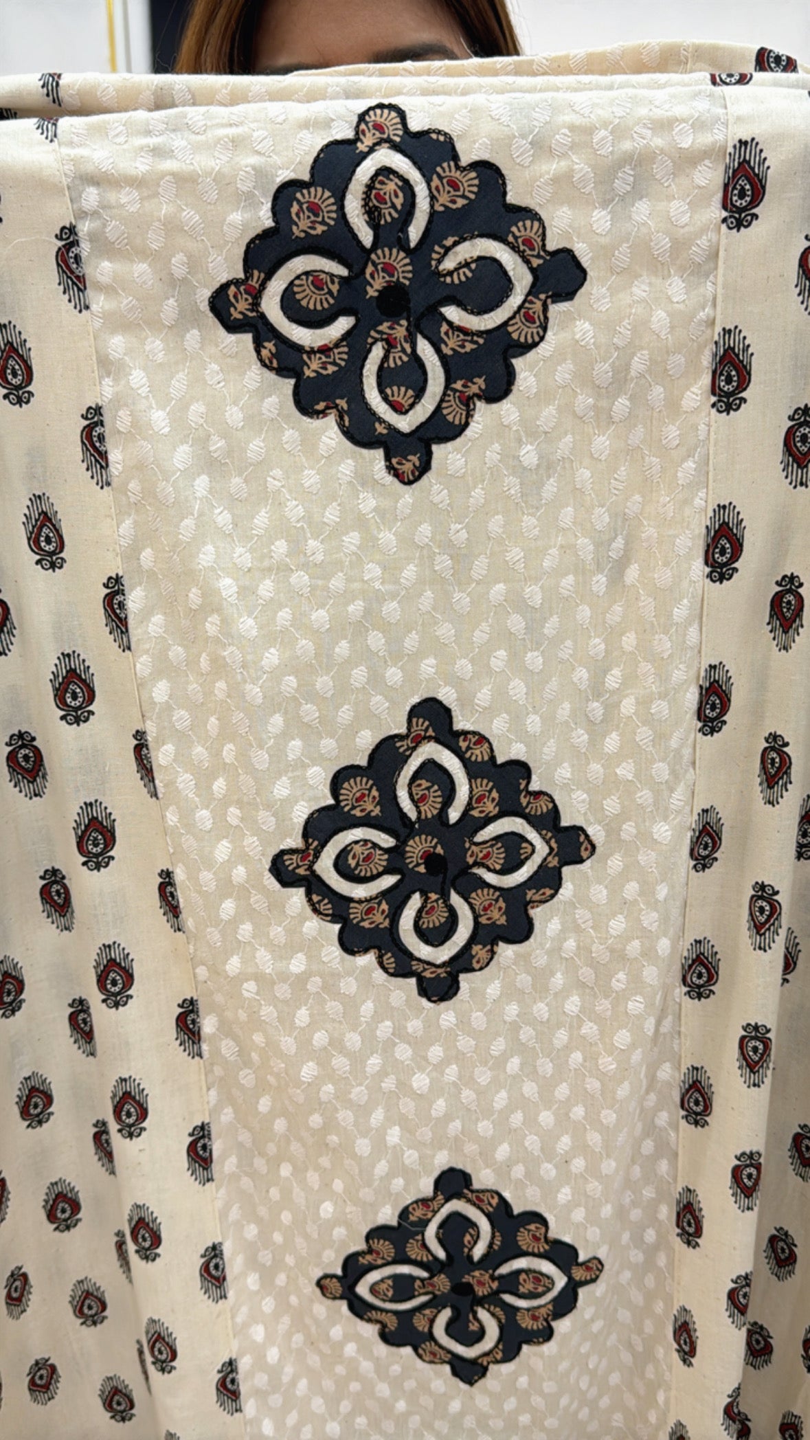 Elegant pure cotton applique suits featuring intricate floral designs on light cream fabric