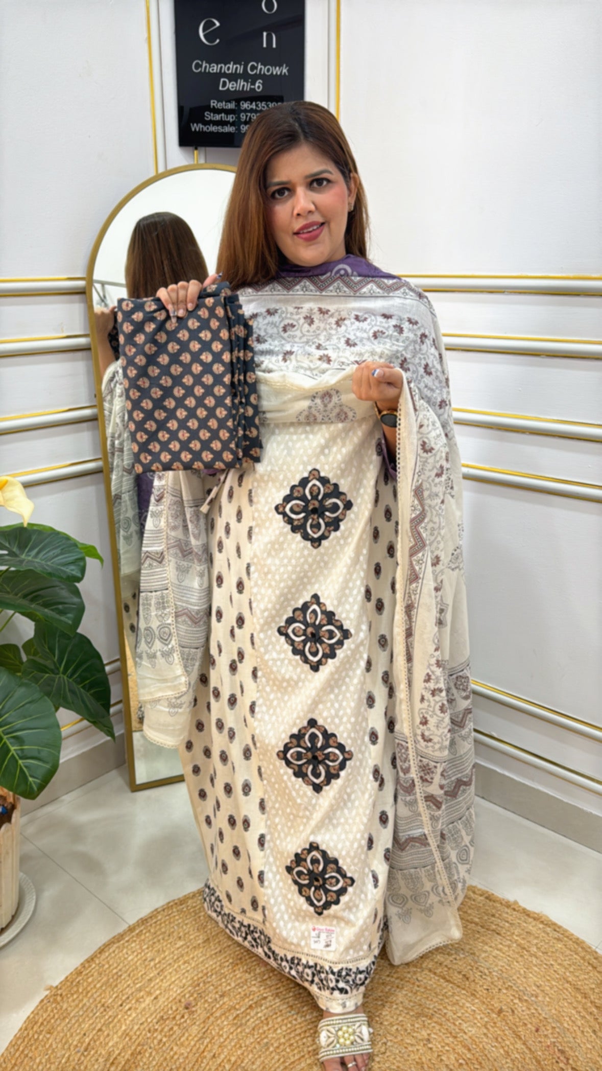 Model showcasing a pure cotton applique suit with a matching dupatta, perfect for festive occasions