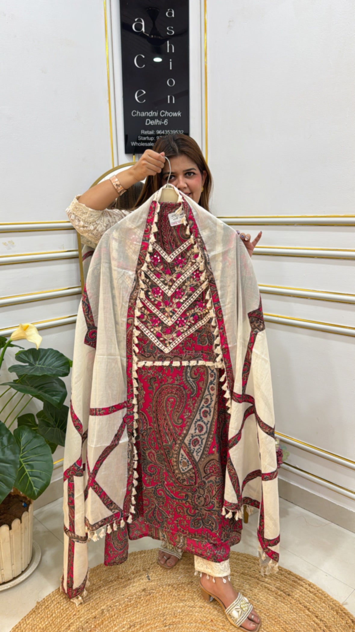 Model showcasing pure cotton designer suits with intricate embroidery and elegant design details