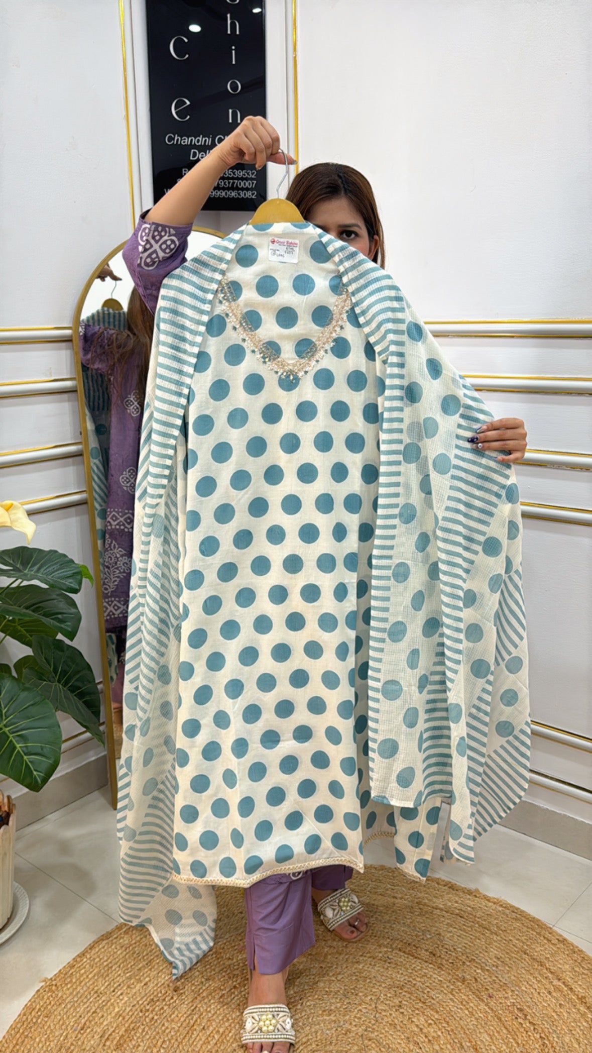 Model displaying a pure cotton polka dots suit with blue polka dots and striped pattern on the front