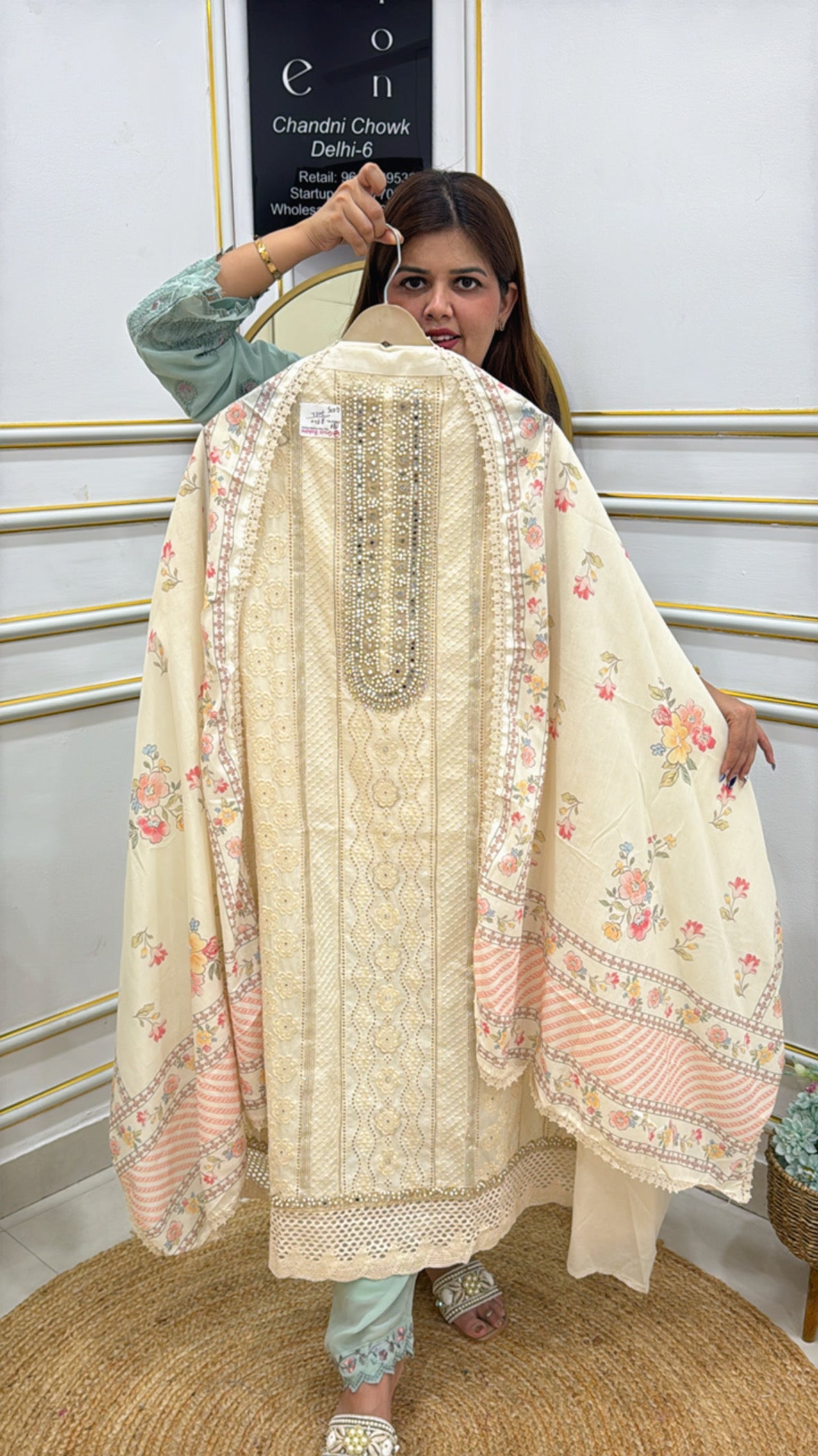 Elegant lady showcasing a pure cotton unstitched suit with floral patterns and intricate detailing