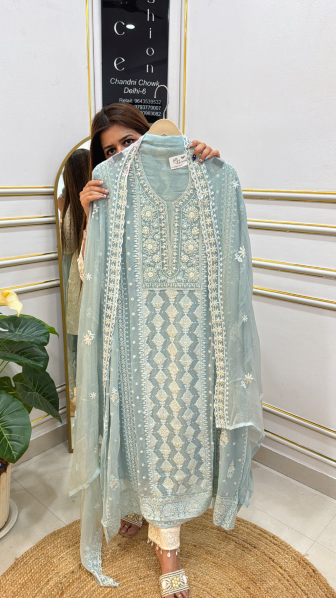 Model displaying a pure georgette Lucknowi suit in light blue with intricate embroidery details