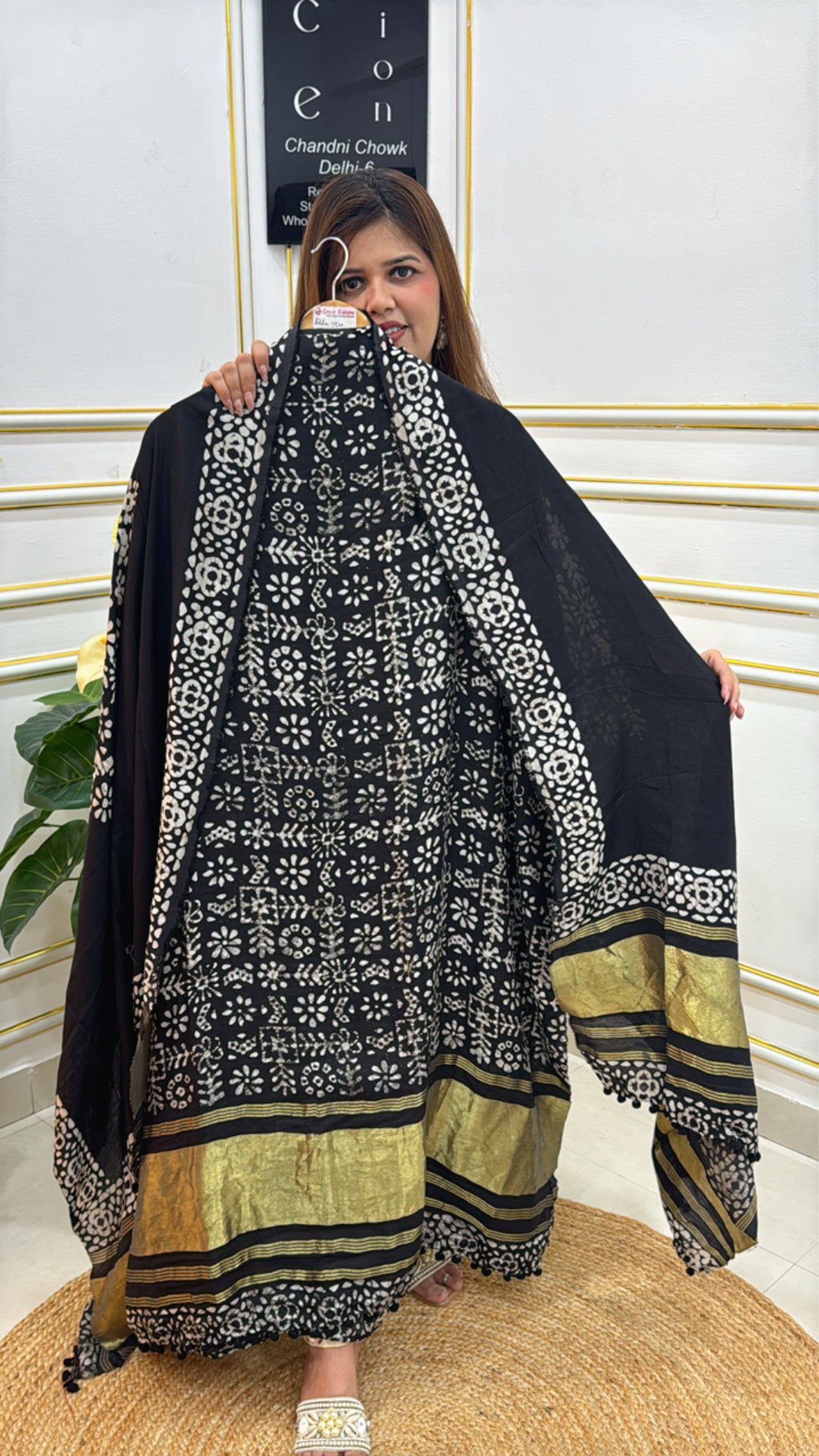 Trendy cotton modal unstitched suit in black with intricate floral prints and golden detailing