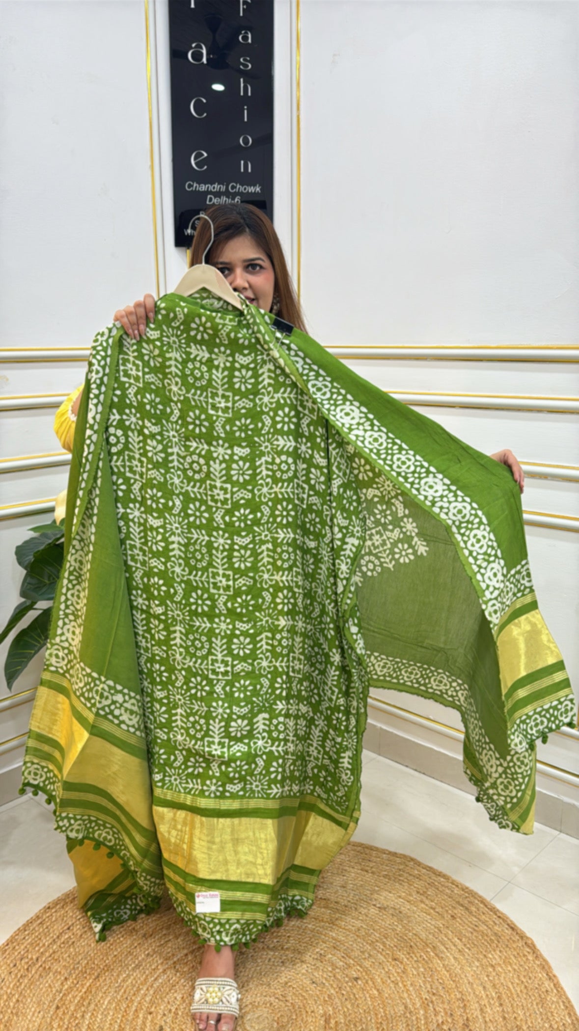A model showcasing a trendy cotton modal unstitched suit in green and yellow hues with intricate patterns
