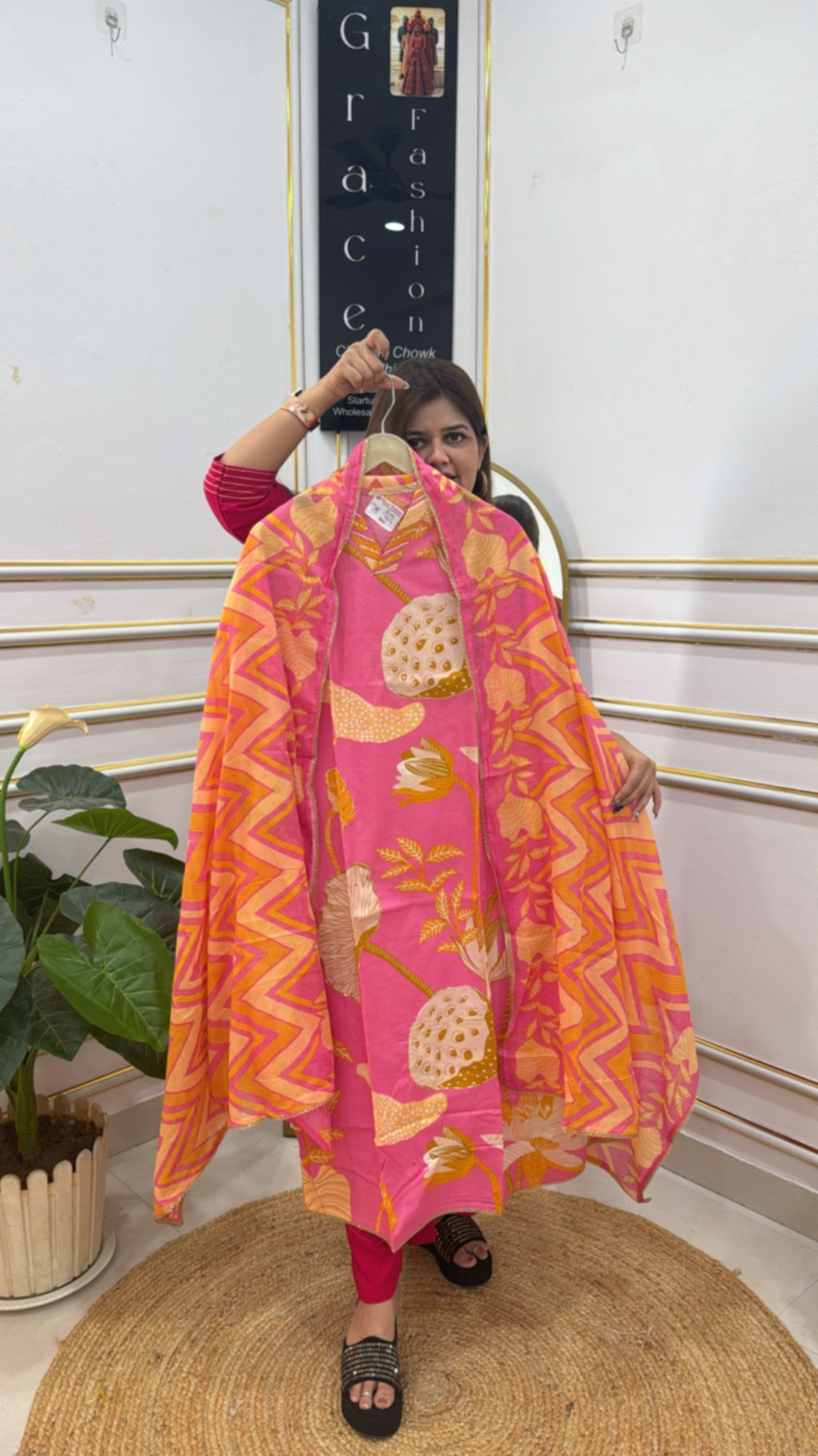 Colorful unstitched ladies suits online featuring vibrant floral patterns in pink and orange hues