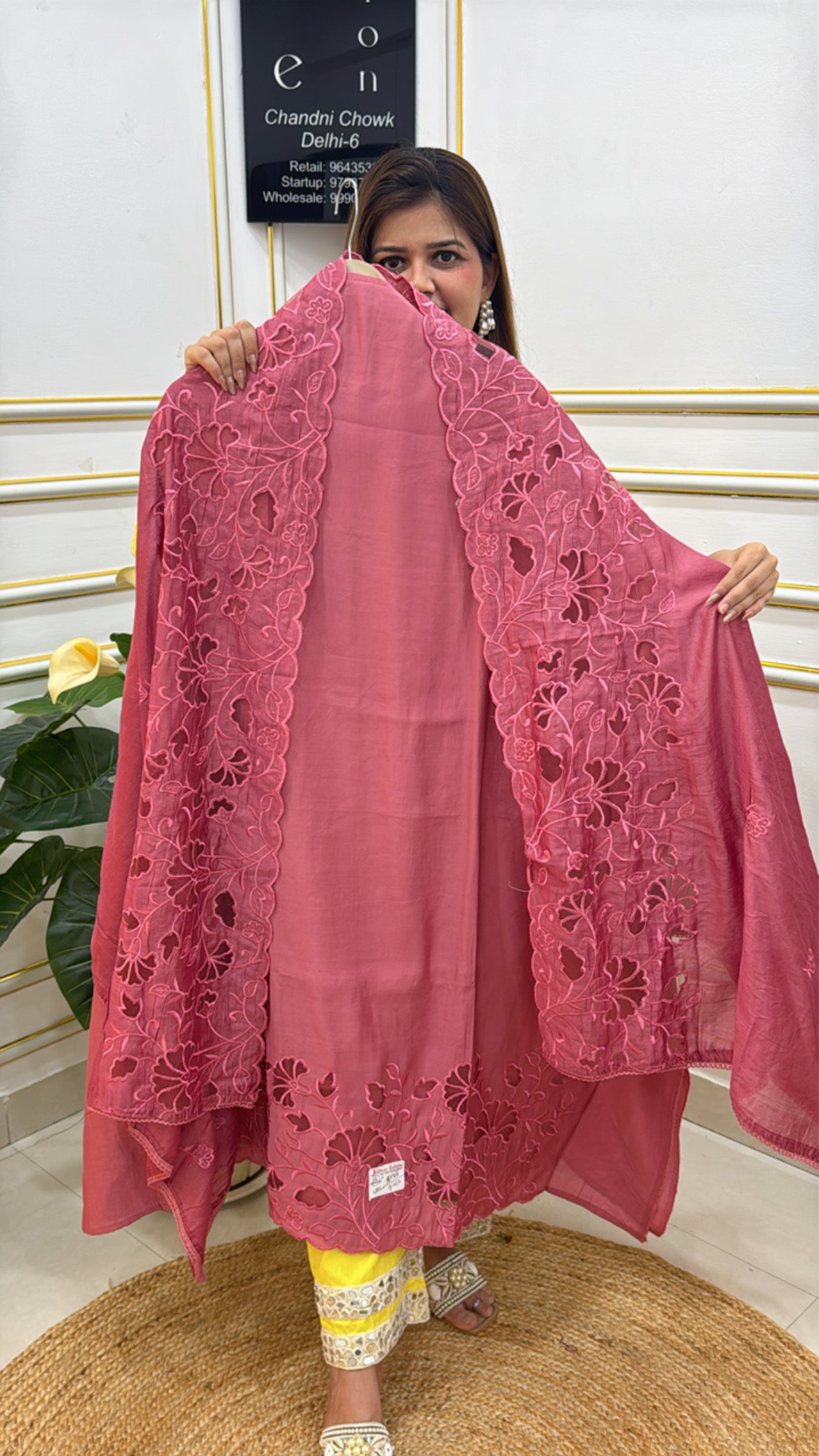 Chiffon shawl with intricate embroidery in rose color, draped elegantly by a model