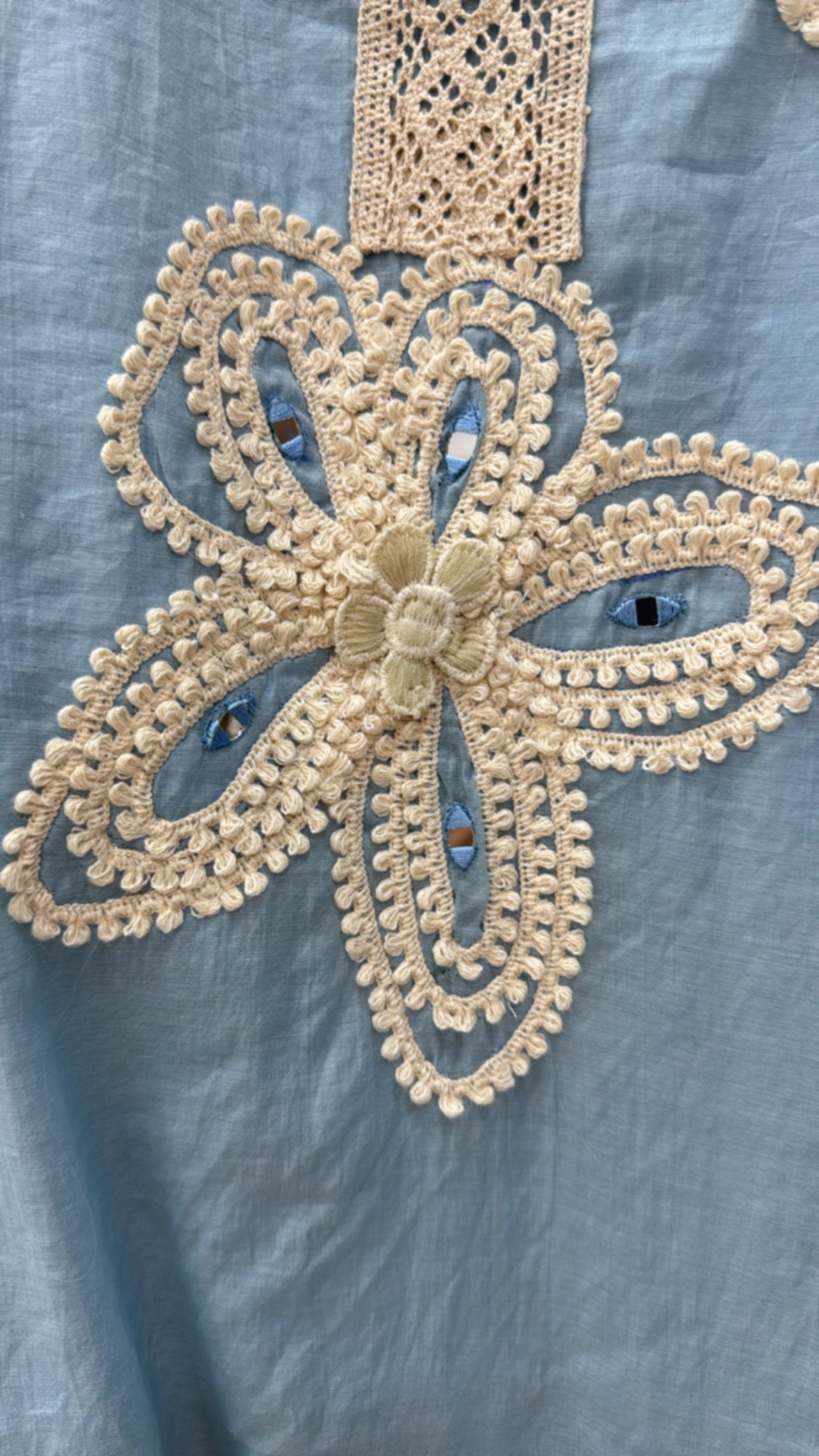 Light blue linen blouse featuring intricate cream floral crochet applique detail