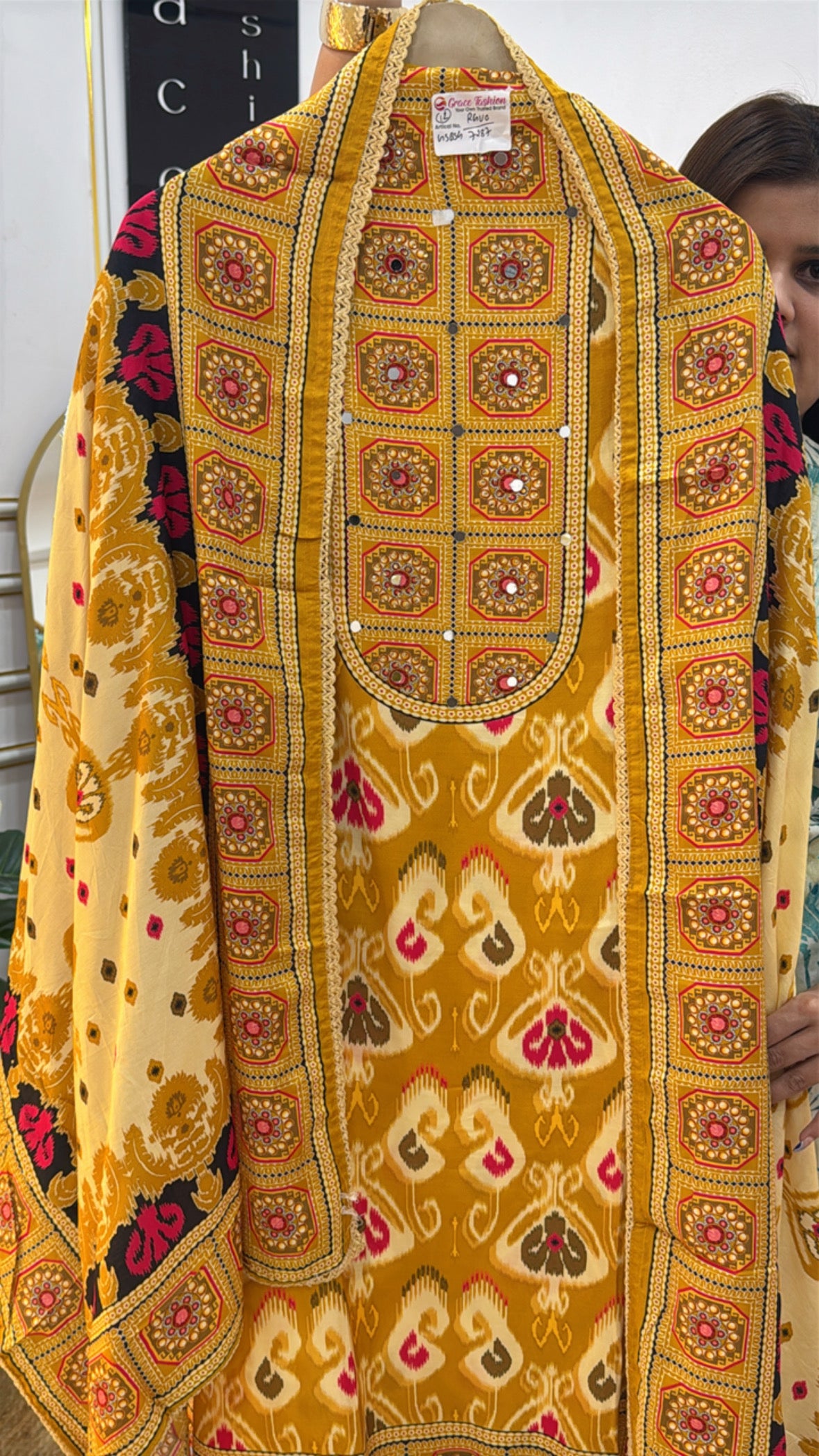 Traditional yellow embroidered tunic from The Grace Fashion featuring vibrant floral patterns and intricate detailing