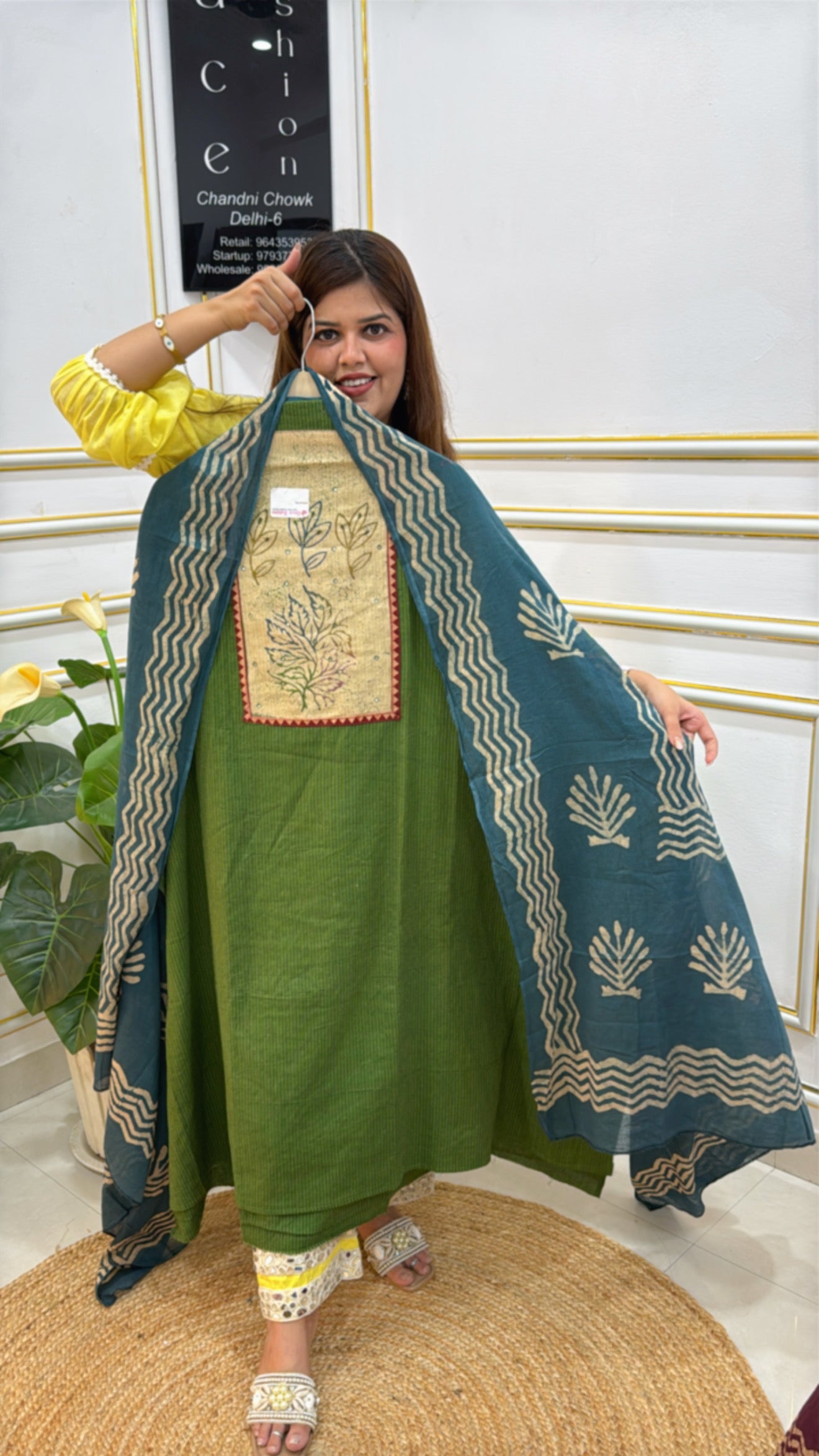 Model showcasing a green kurta with a blue embroidered dupatta from The Grace Fashion